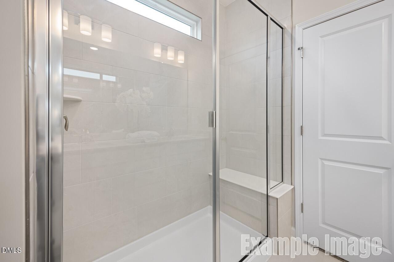 Modern frameless glass shower with white subway tile walls in master bath, Davidson Homes The Carter C, Lillington, NC