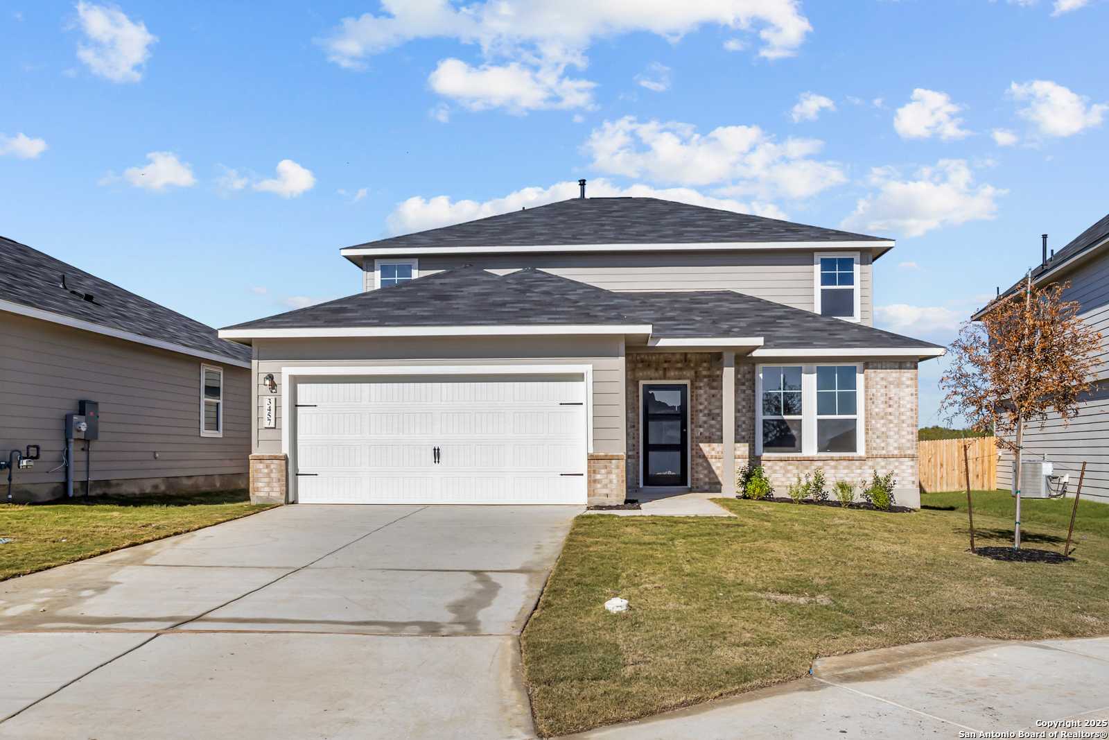 Modern 2-story Davidson Homes Douglas B exterior with 2-car garage, brick accents, and driveway in Horizon Pointe, Converse, Texas