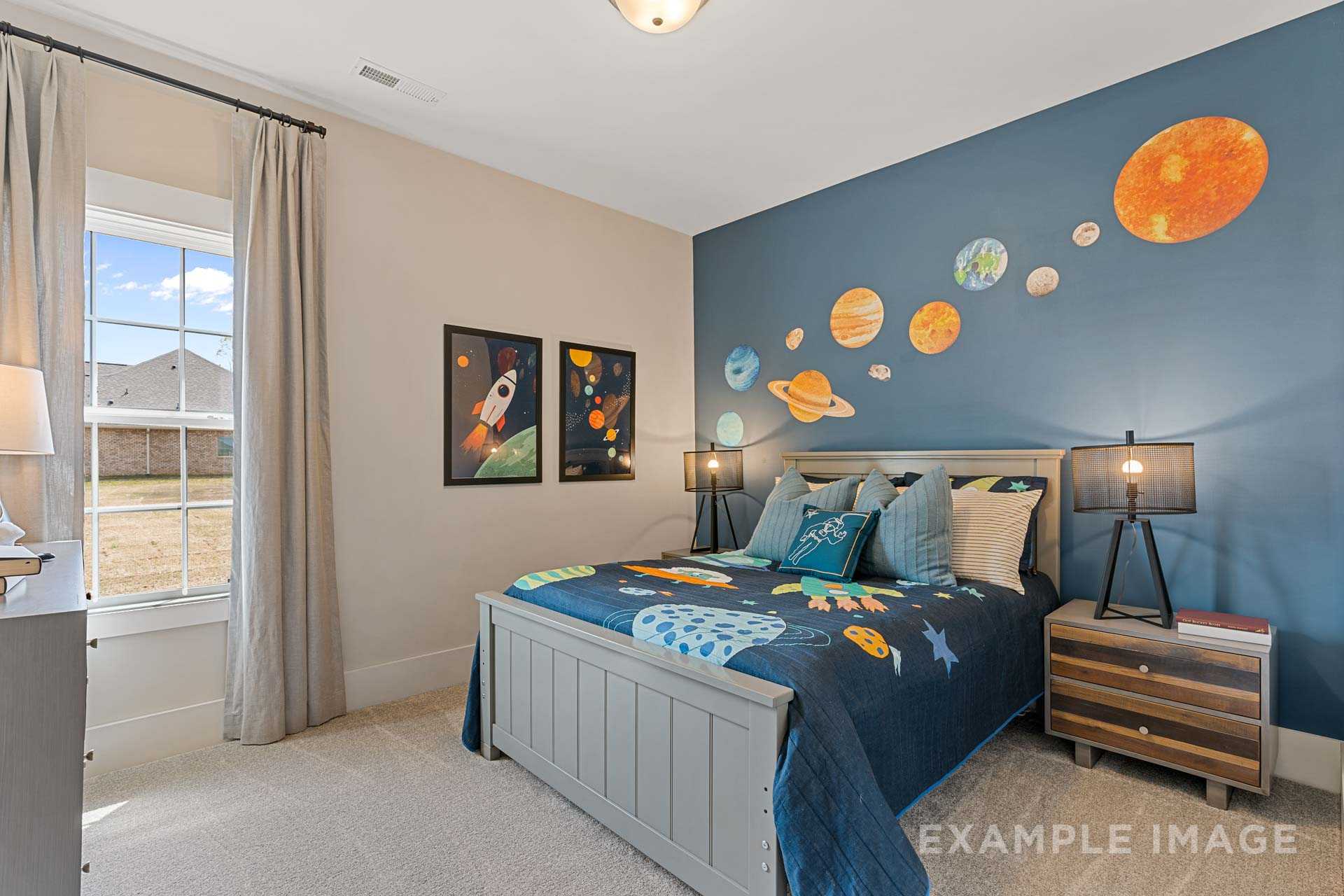 Space-themed kids bedroom in The Rockford by Davidson Homes, navy wall with planets, rocket posters, twin bed with starry bedding