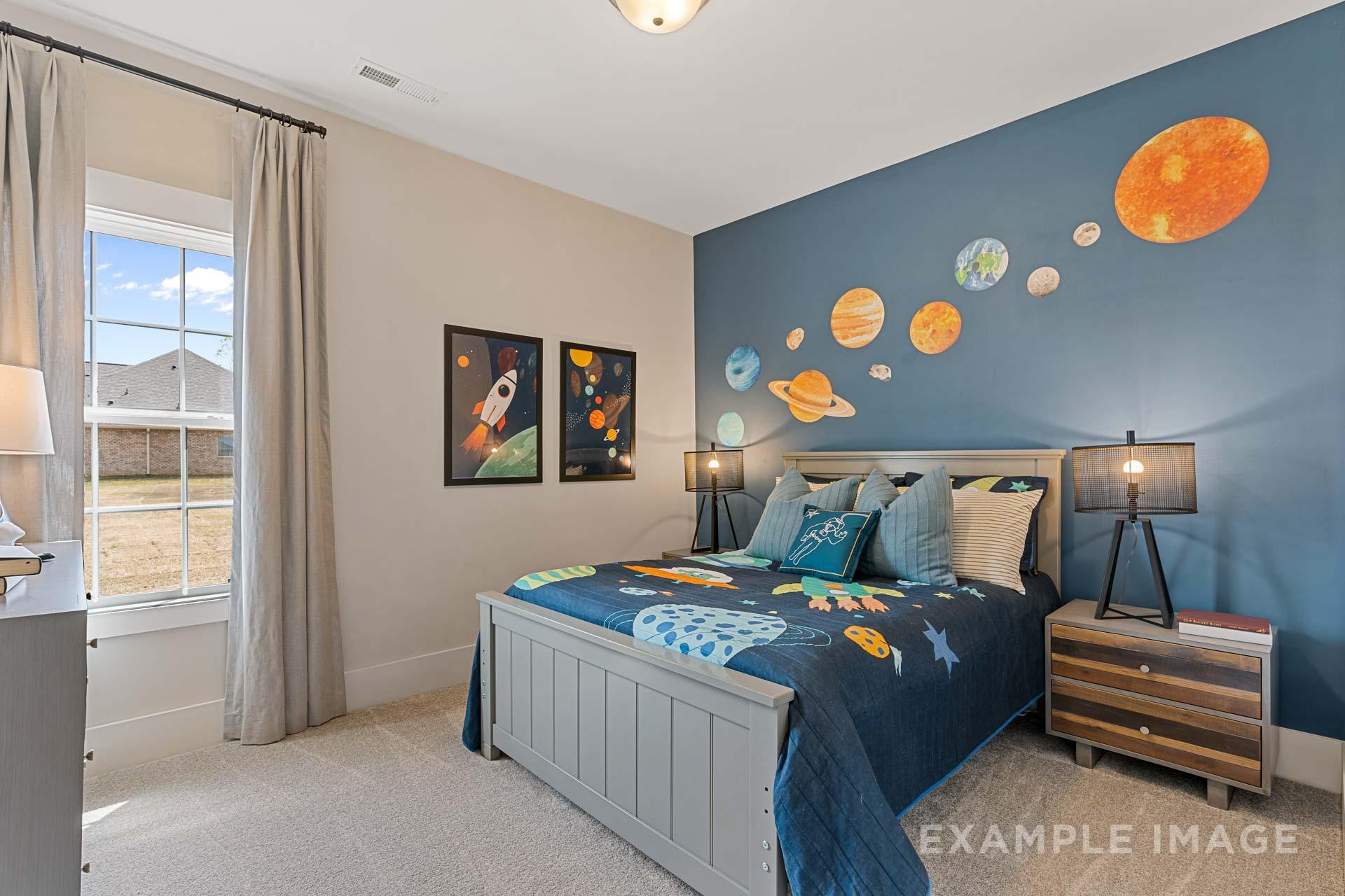 Space-themed kids bedroom in The Rockford by Davidson Homes, navy wall with planets, rocket posters, twin bed with starry bedding