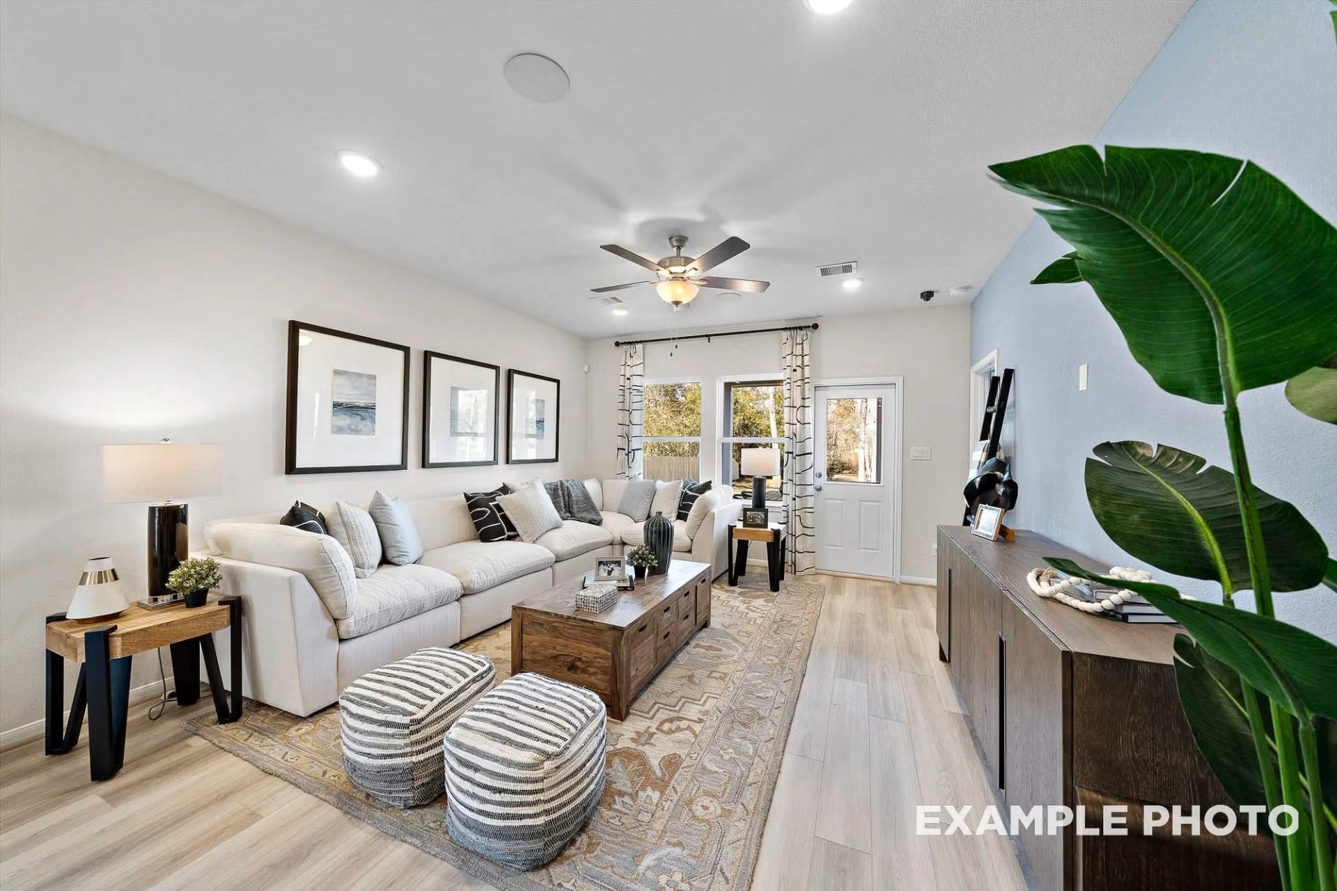 Bright, open-concept living room with white sectional and decor in The San Marcos E floor plan by Davidson Homes.