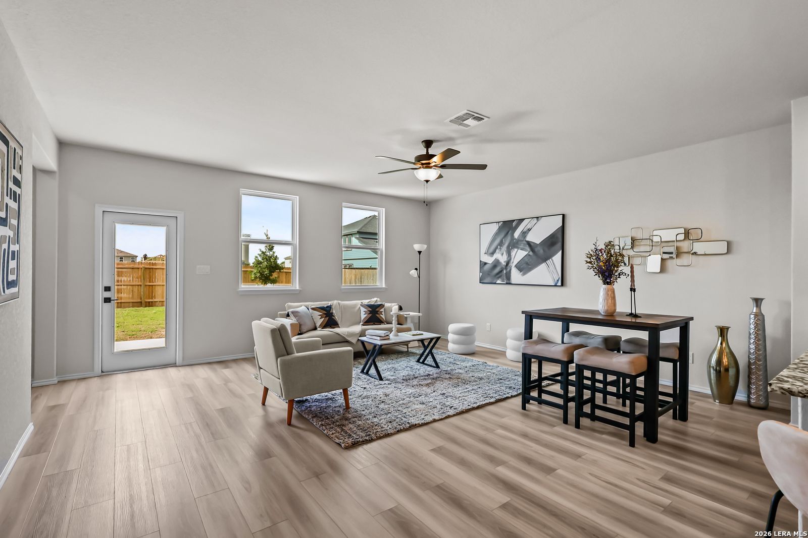 Open-concept living room with wood-look flooring in The Douglas C floor plan at Hannah Heights in Seguin, Texas.