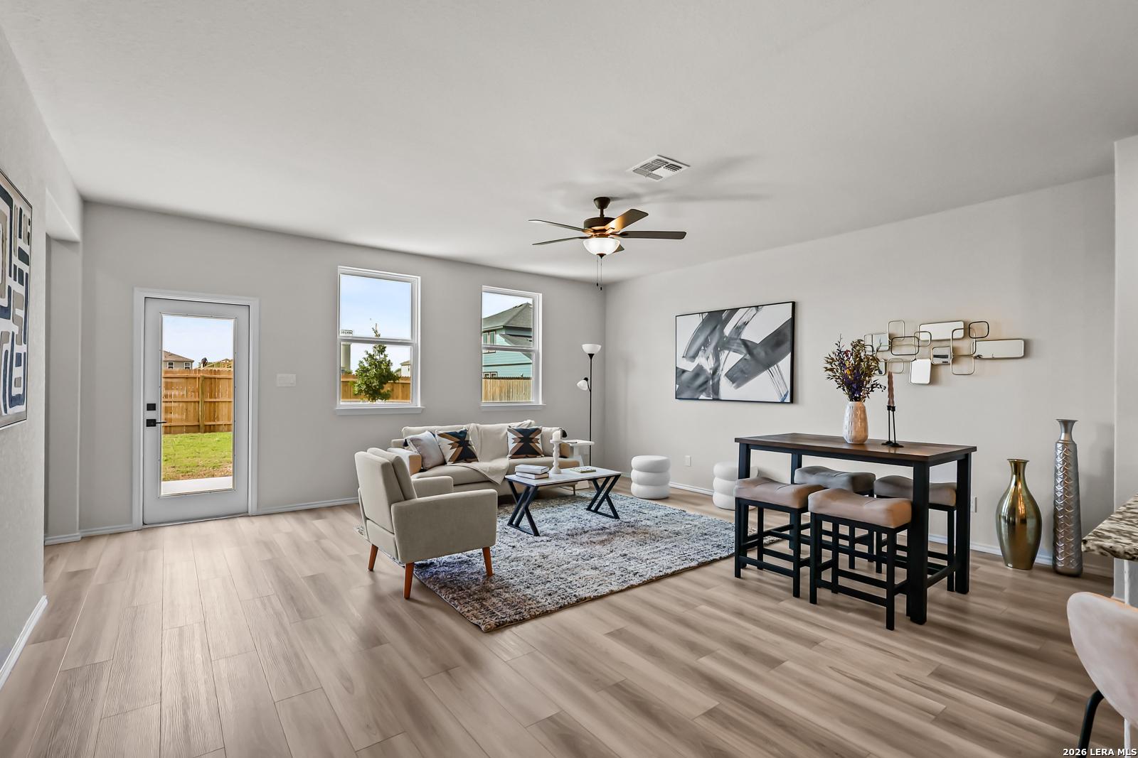 Open-concept living room with wood-look flooring in The Douglas C floor plan at Hannah Heights in Seguin, Texas.