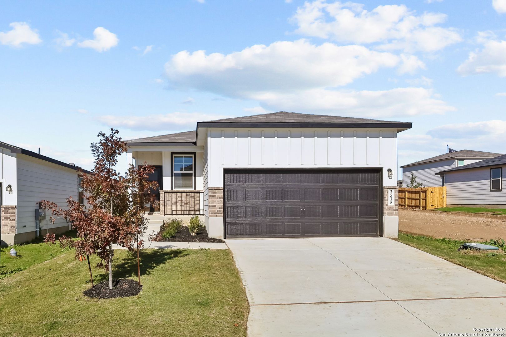 Modern single-story 4-bedroom home exterior with 2-car garage, driveway, and front yard landscaping in Applewhite Meadows, San Antonio