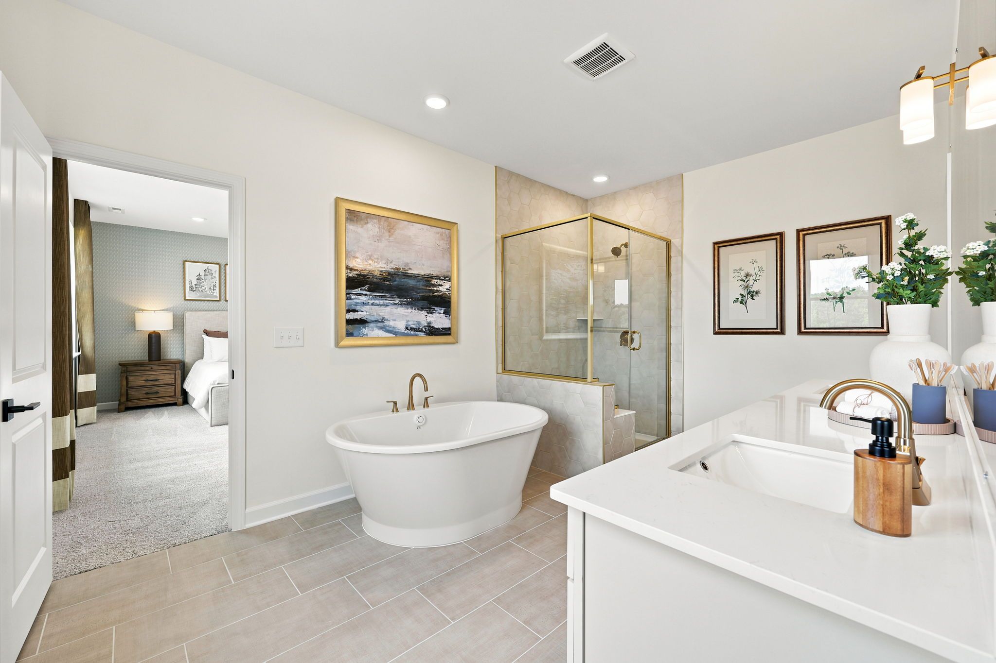 Luxury primary bathroom at Montrose in Aberdeen, NC by Davidson Homes featuring a soaking tub and glass-enclosed shower.