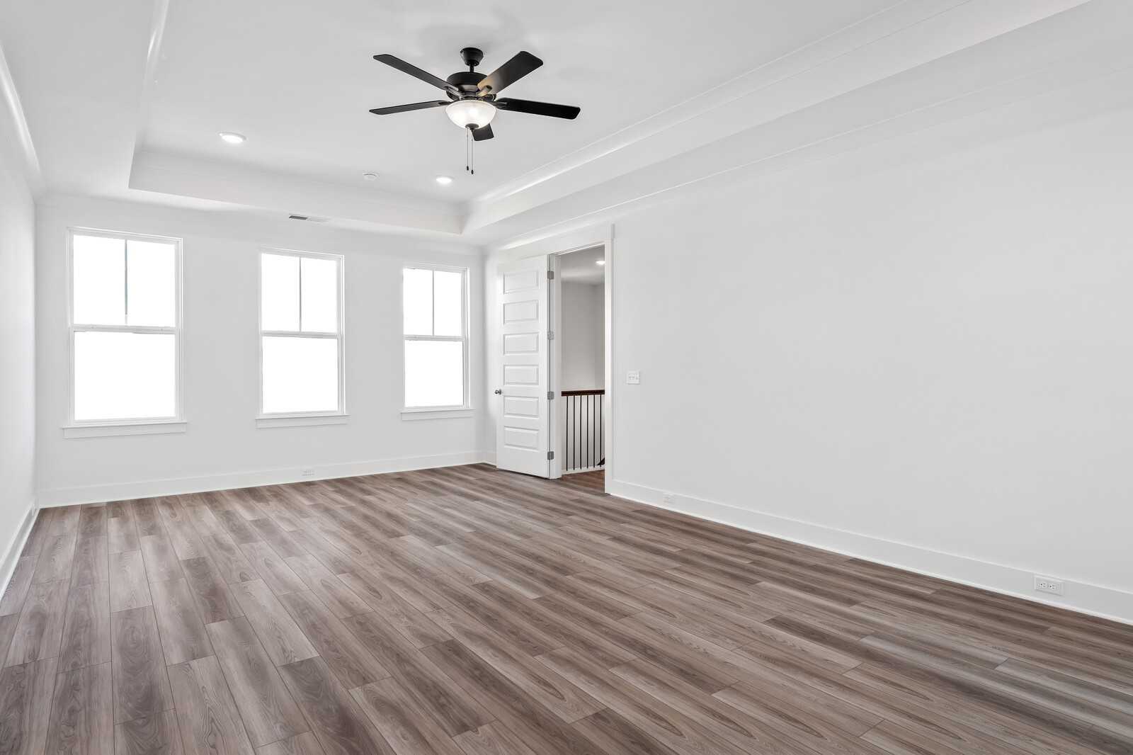 Bright upstairs loft with hardwood floors, large windows, ceiling fan, and balcony overlook in The Alston A, Shelton Square, Murfreesboro, TN