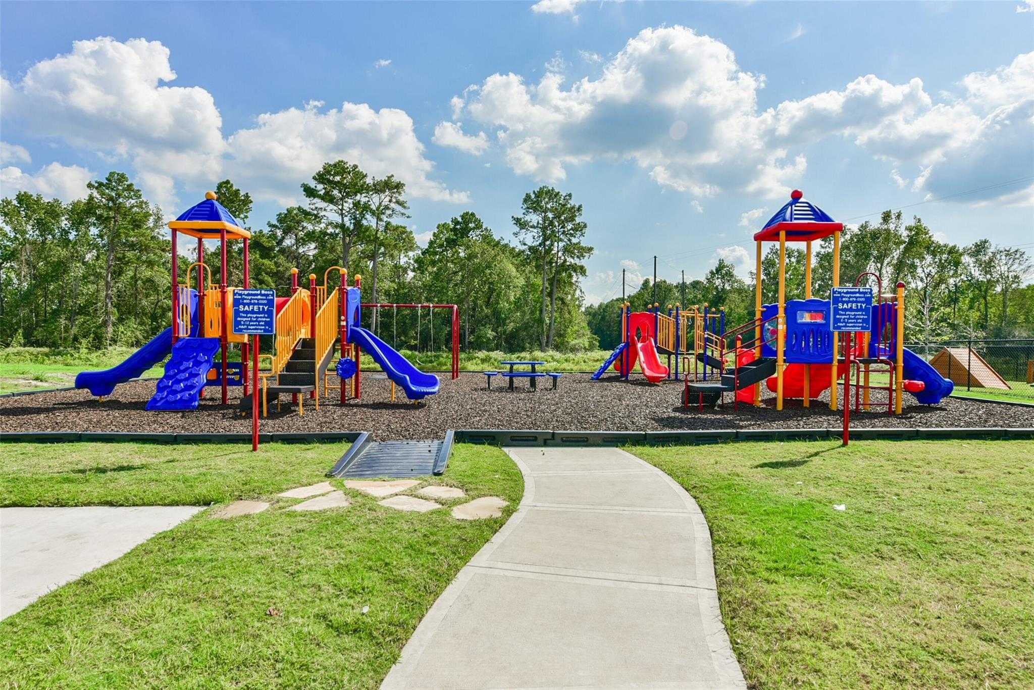 Vibrant playground with colorful slides, swings and climbing structures in The Villages at WestPointe, Dayton, Texas
