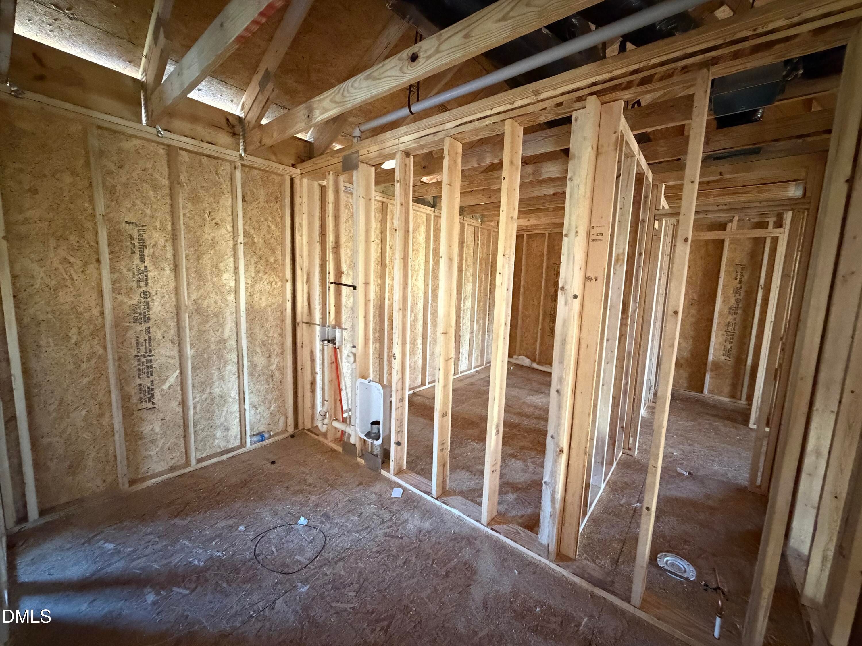 Interior wood framing with exposed studs and plywood walls in The Hickory II B 5-bedroom home, Wellers Knoll, Lillington, NC