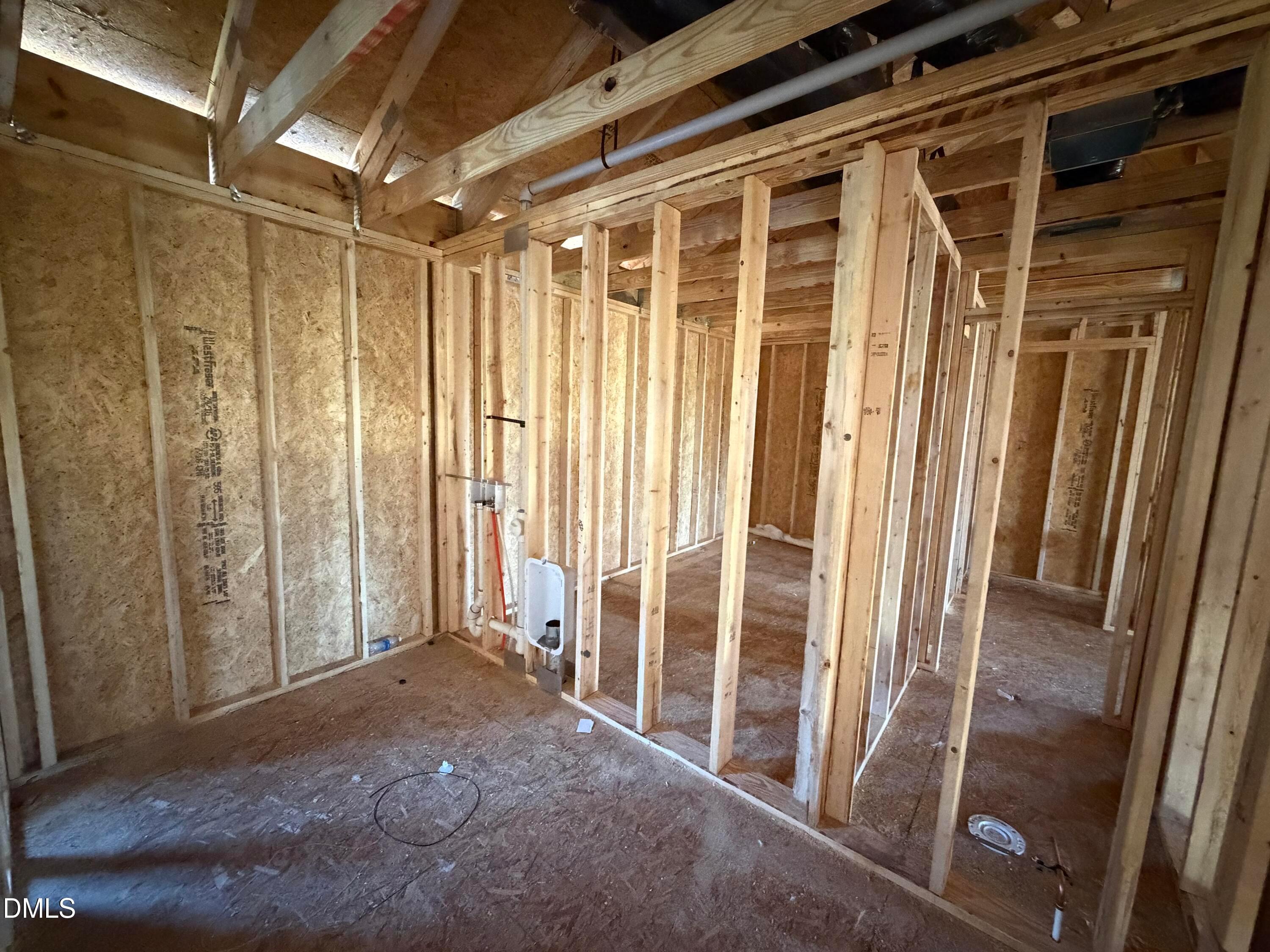 Interior wood framing with exposed studs and plywood walls in The Hickory II B 5-bedroom home, Wellers Knoll, Lillington, NC