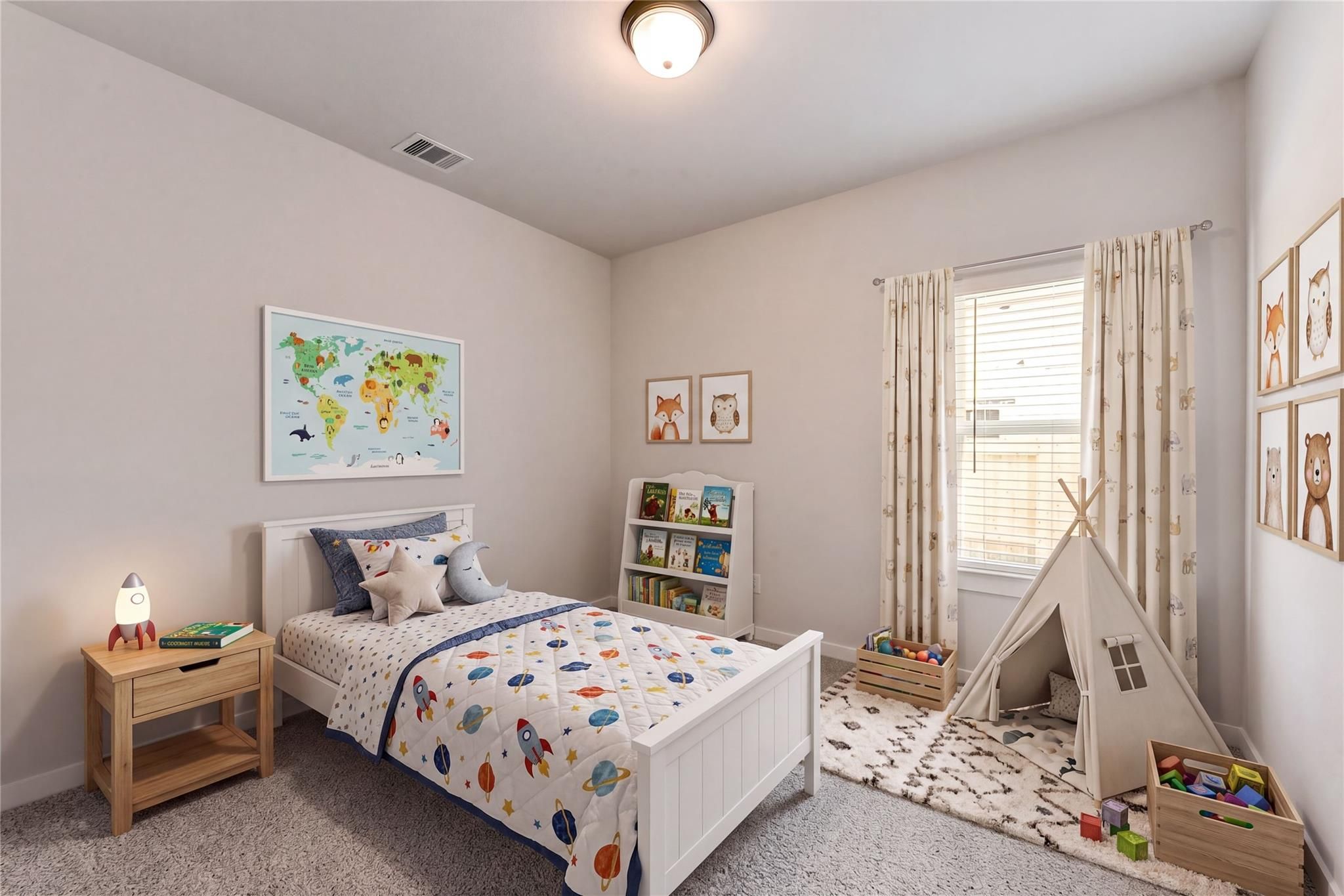 Cozy child's bedroom with space-themed bedding, rocket lamp, play tent, world map, and books in Davidson Homes The Costa C, Dayton, Texas