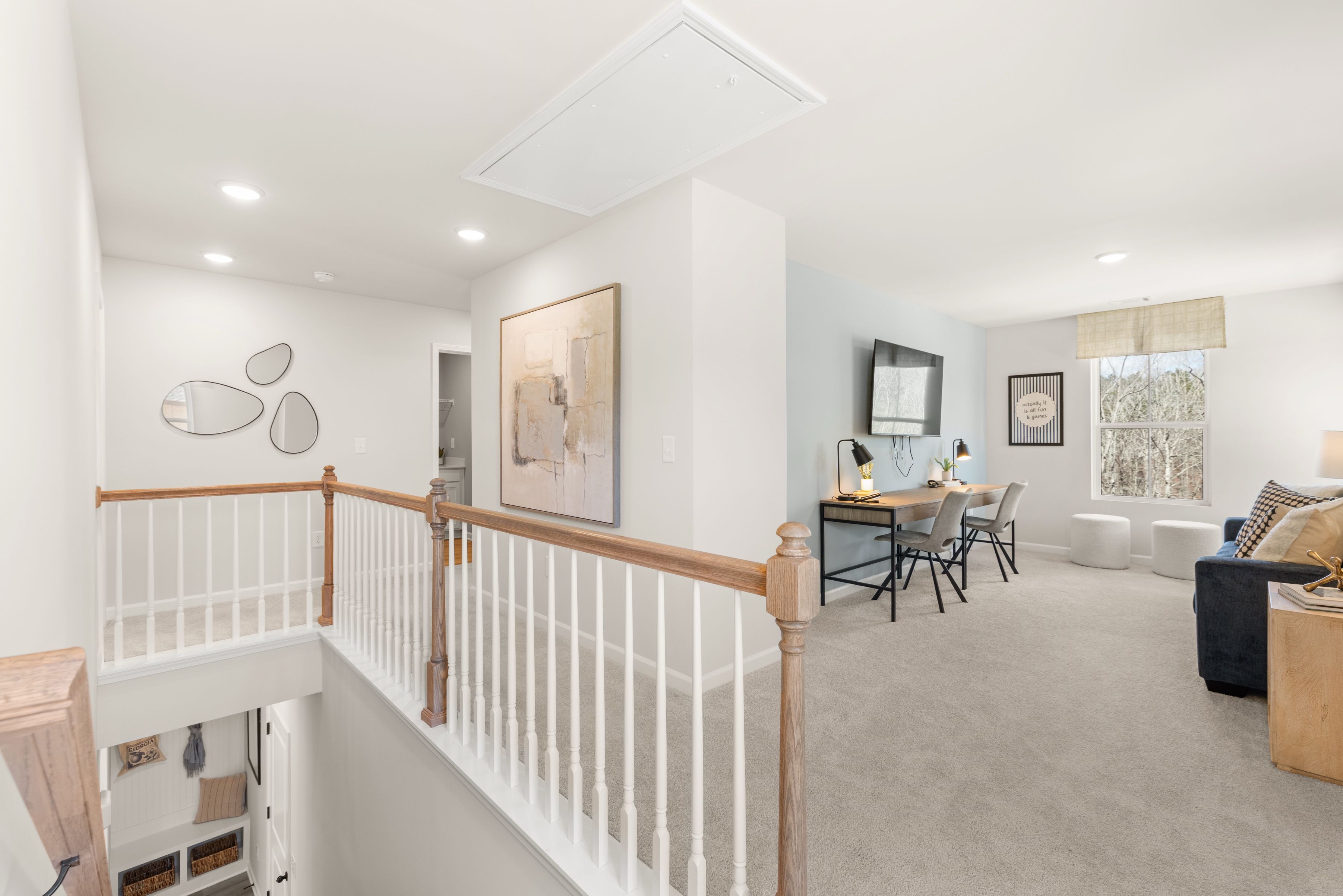 Spacious loft area at Links Crossing in Auburn, AL by Davidson Homes featuring a home office space and lounge seating.