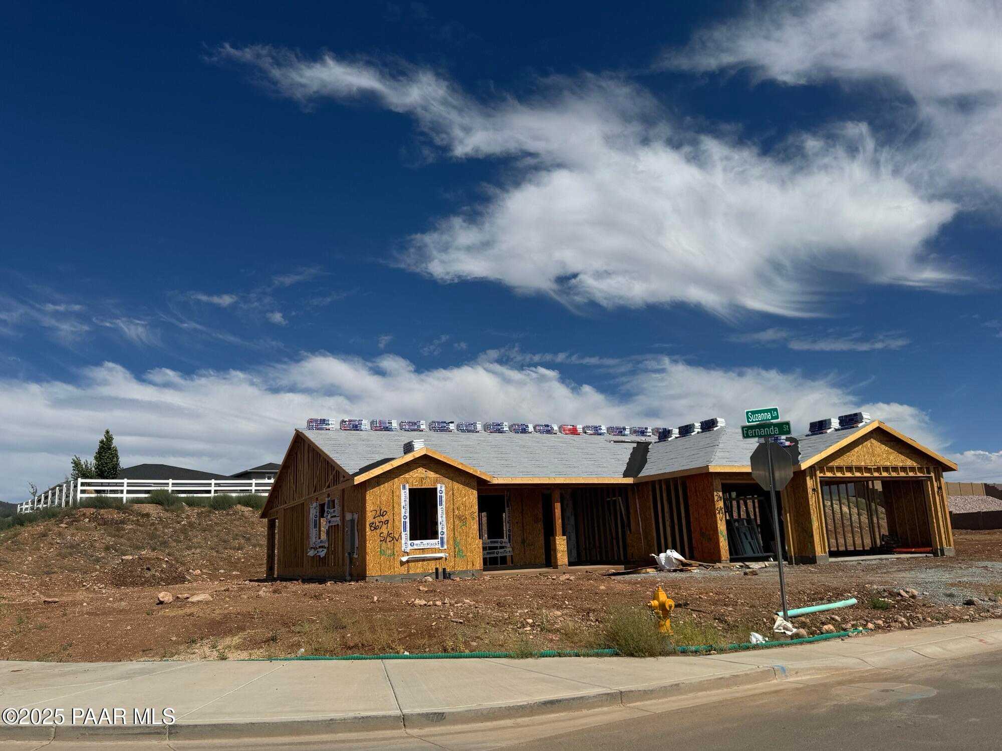 Under-construction single-story 3-car garage home frame with roof trusses in Morningstar, Prescott Valley, Arizona - Evermore Homes The Monarch B