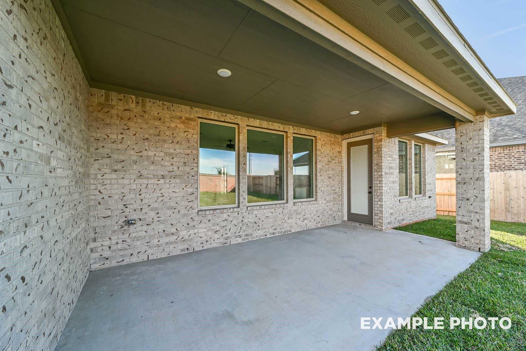 Covered patio with ceiling fan, large windows, and brick exterior on 4-bedroom The Philip C home in Sierra Vista, Rosharon, Texas