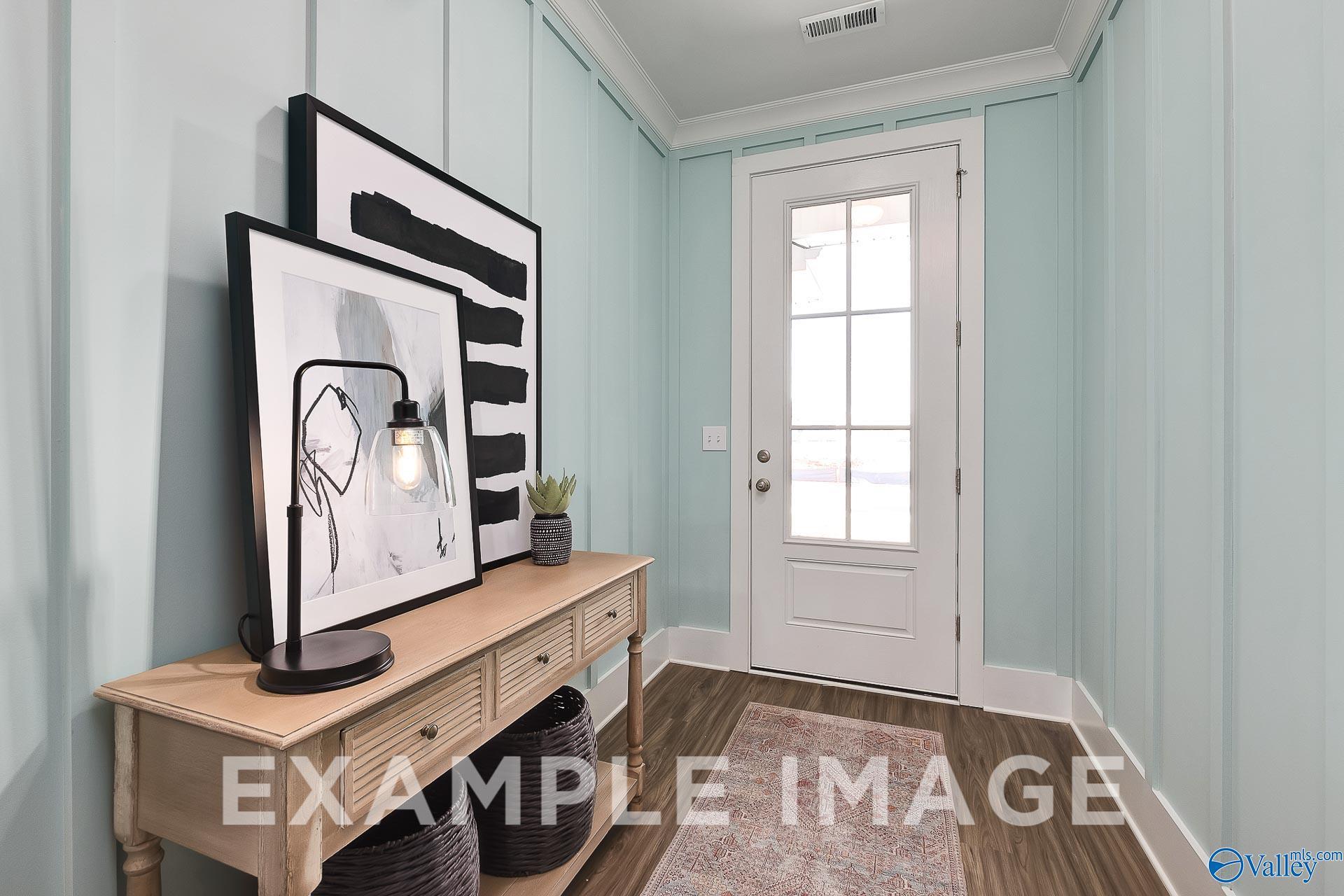 Welcoming foyer with board and batten walls and wood-look flooring in The Everett B home at The Meadows, Athens, Alabama.