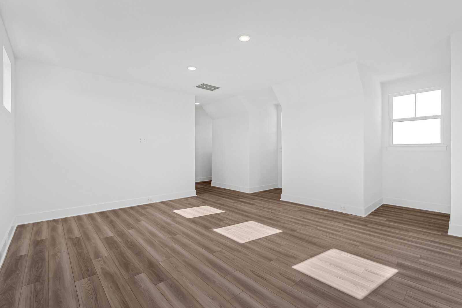 Spacious upstairs loft with hardwood floors, white walls, recessed lights, and windows in The Alston A floor plan, Murfreesboro