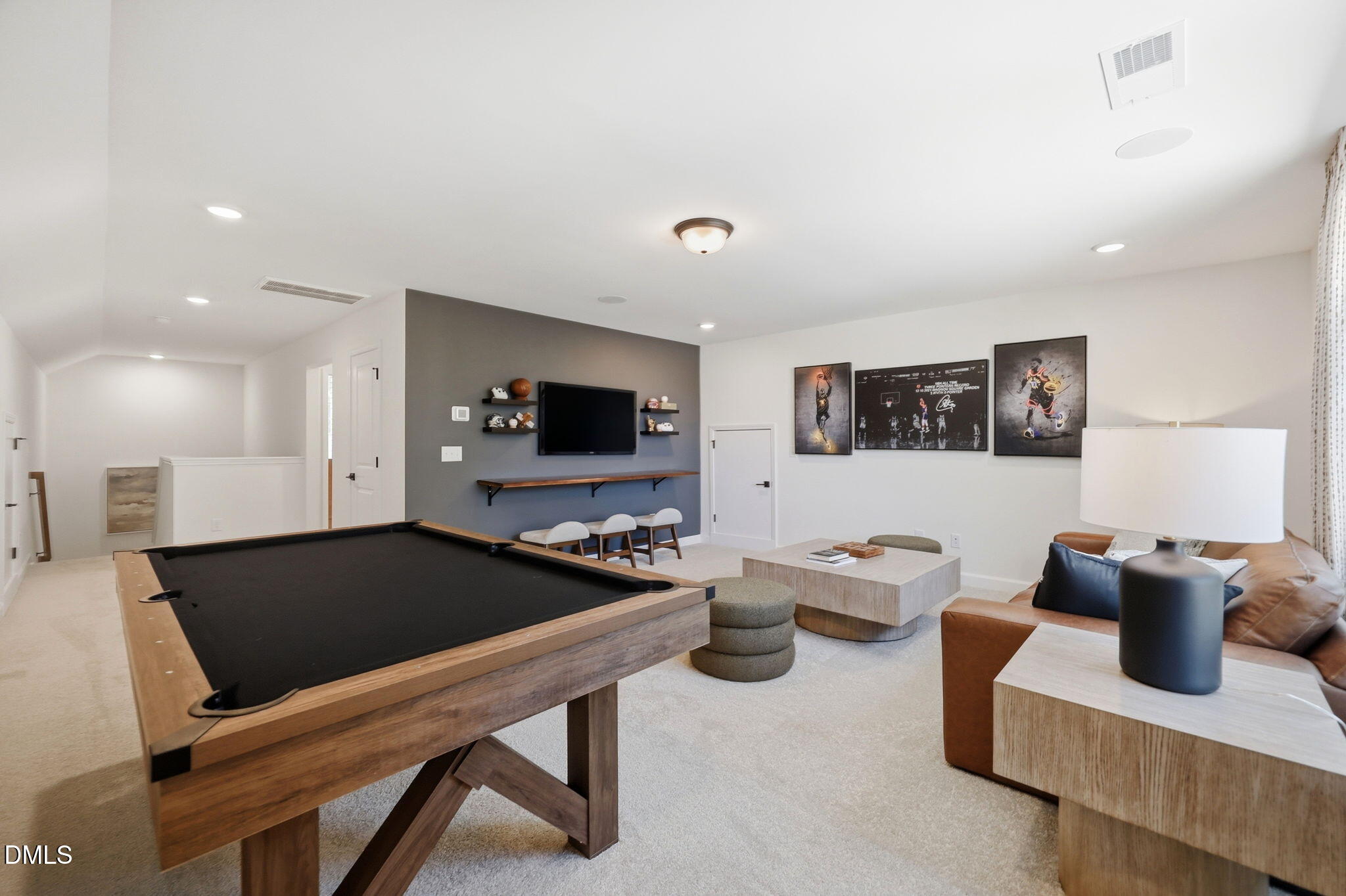 Spacious game room with pool table and cozy lounge area in The Aspen B floor plan by Davidson Homes in Wendell, NC.