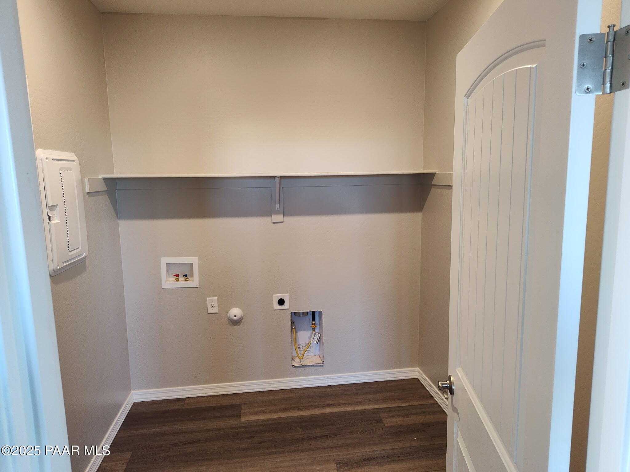 Spacious laundry room with utility sink, washer dryer hookups, and electrical panel in Davidson Homes The Frontier A, Prescott Valley, Arizona