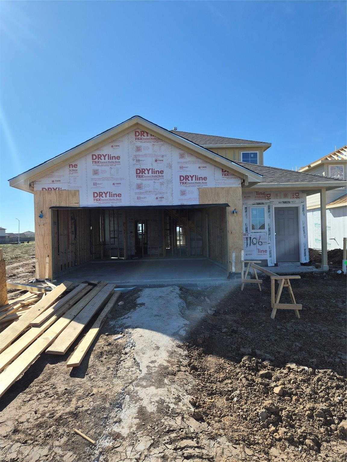 Under-construction two-story 5-bedroom home with open 2-car garage by Davidson Homes, San Marcos E plan in Emberly, Beasley, Texas
