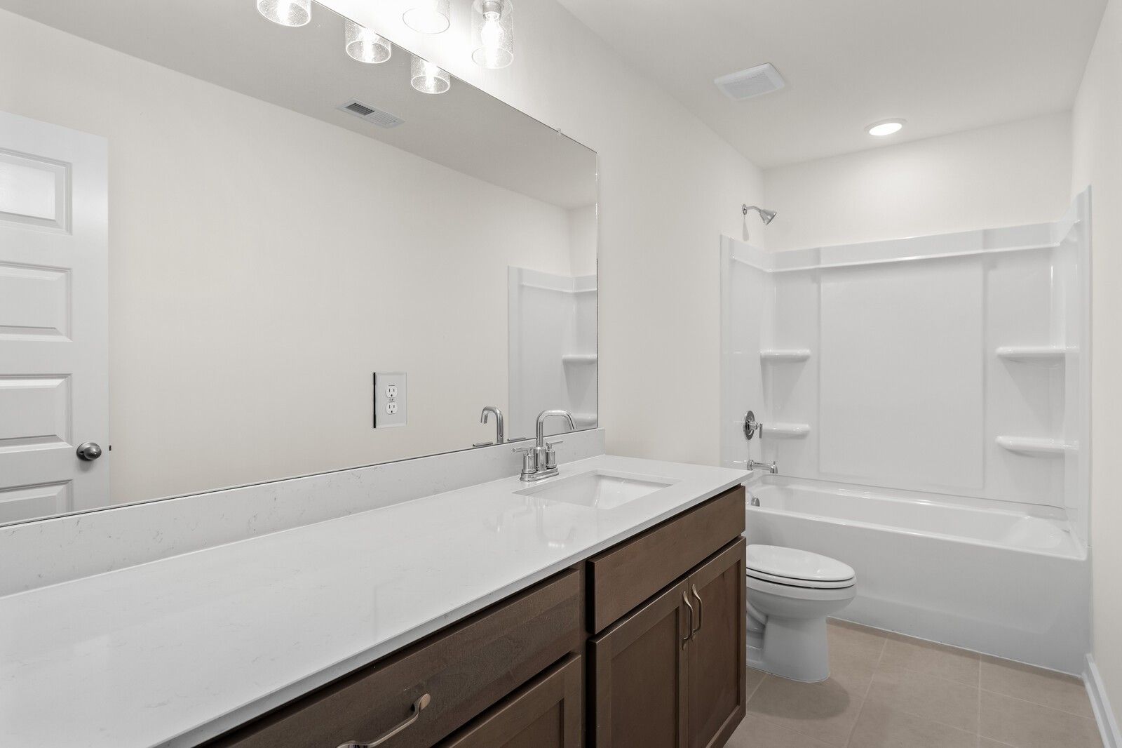 Modern bathroom with white quartz vanity and tub-shower combo in The Henry C floor plan at Benders Cove, Mt. Juliet.