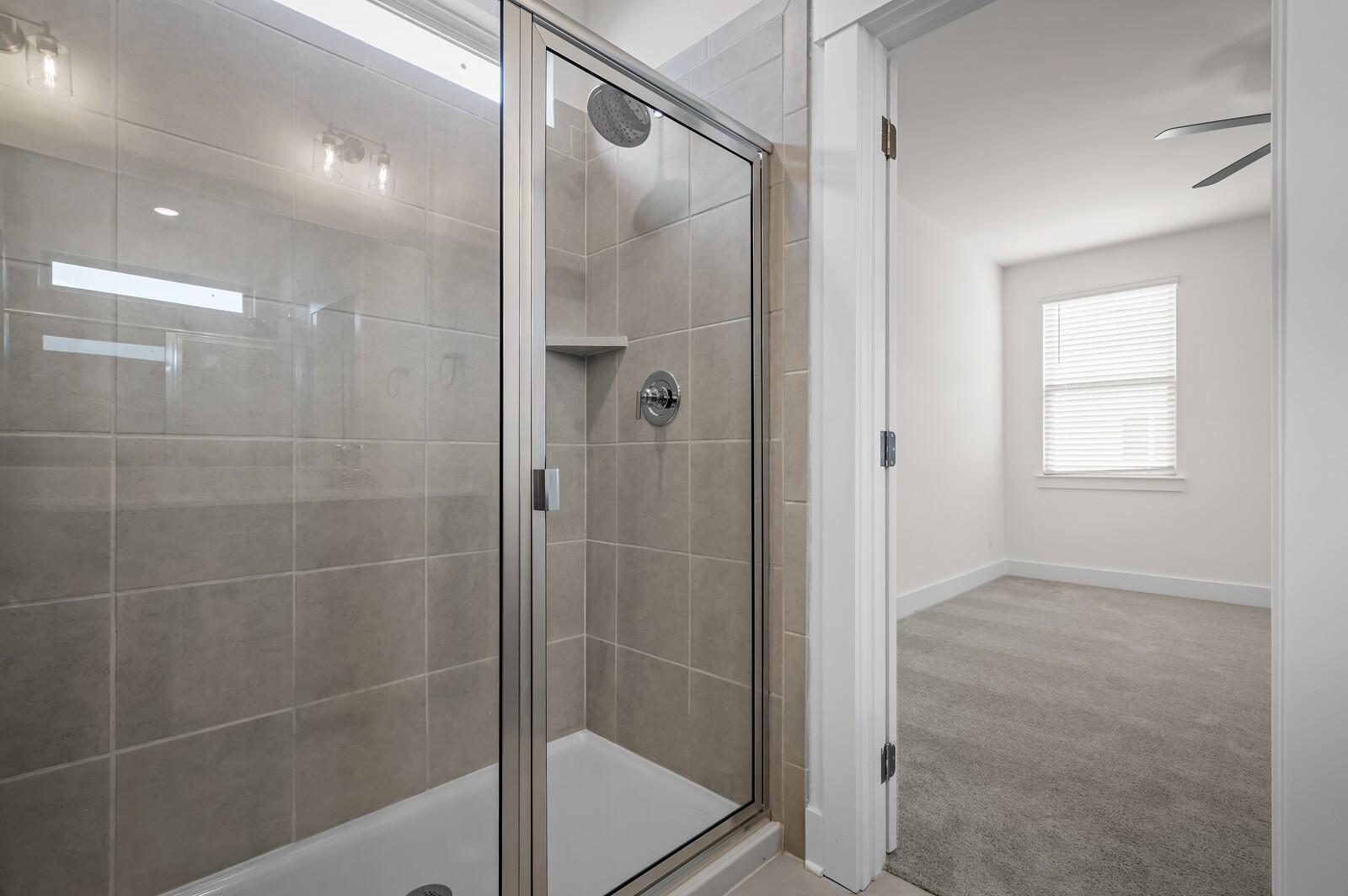Tiled walk-in shower in The Ash A floor plan at Woods Crossing in Gallatin, Tennessee.