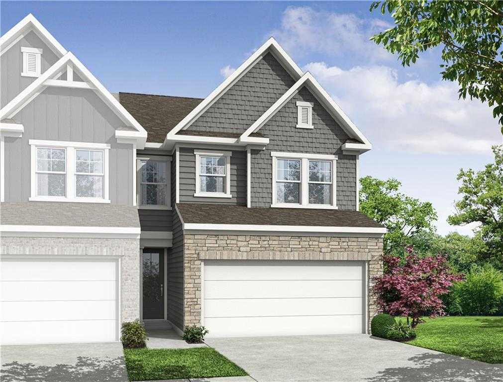 Modern two-story Cary C home with gray siding, stone accents, two-car garage, and lush landscaping in Lake Shore, Winder, Georgia