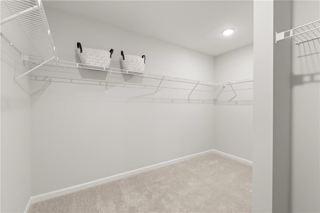 Spacious walk-in closet with wire shelving in The Wake B floor plan at Hemingway, Cumming, Georgia.