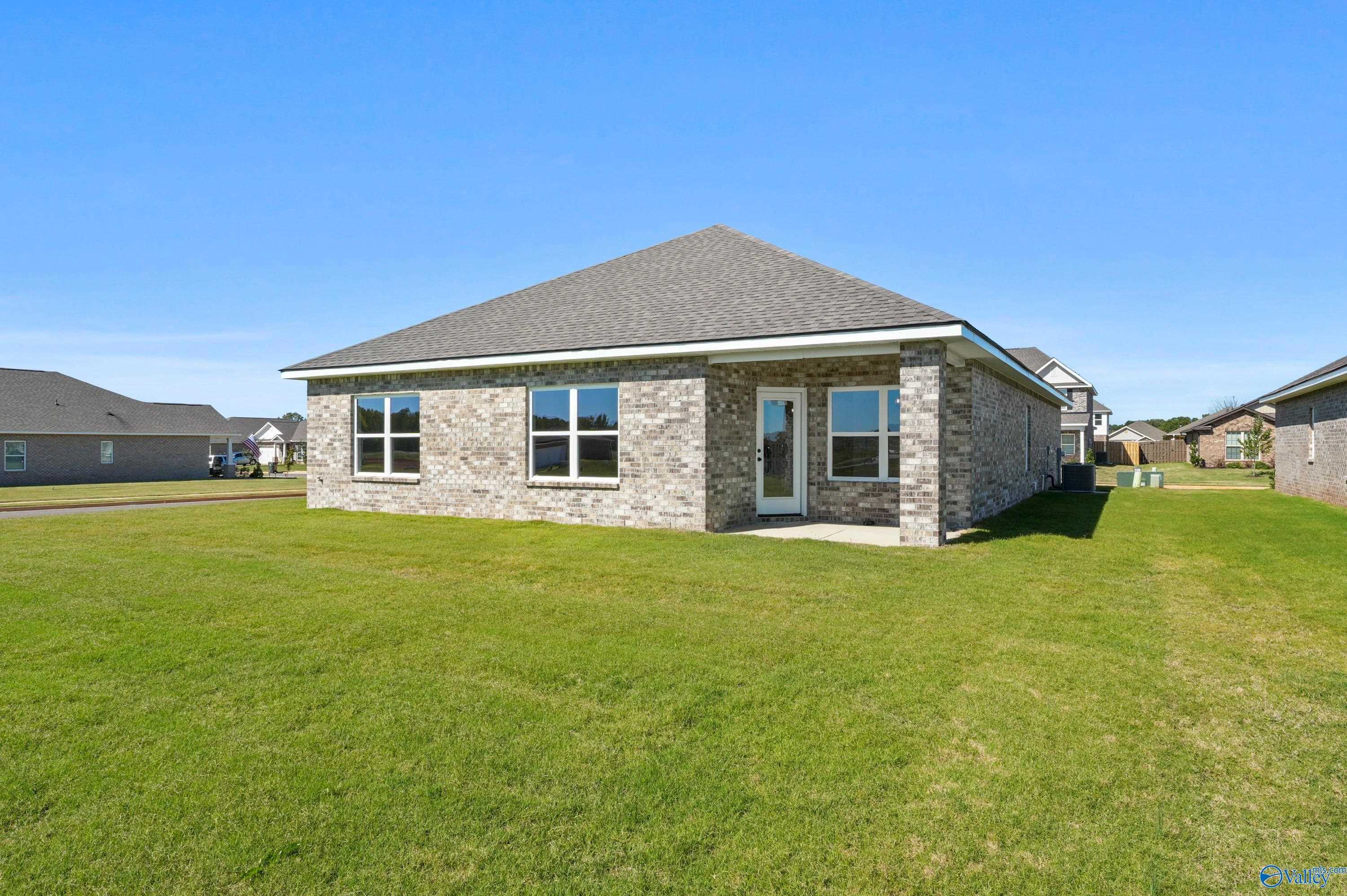Brick single-story 4-bedroom home with 2-car garage, brick exterior and green lawn in Clearview, Hazel Green, Alabama Davidson Homes Daphne C