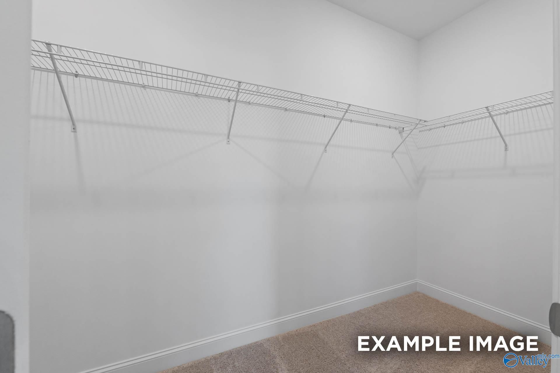 Spacious walk-in closet with wire shelving in The Montgomery B master suite by Davidson Homes, Hartselle, Alabama