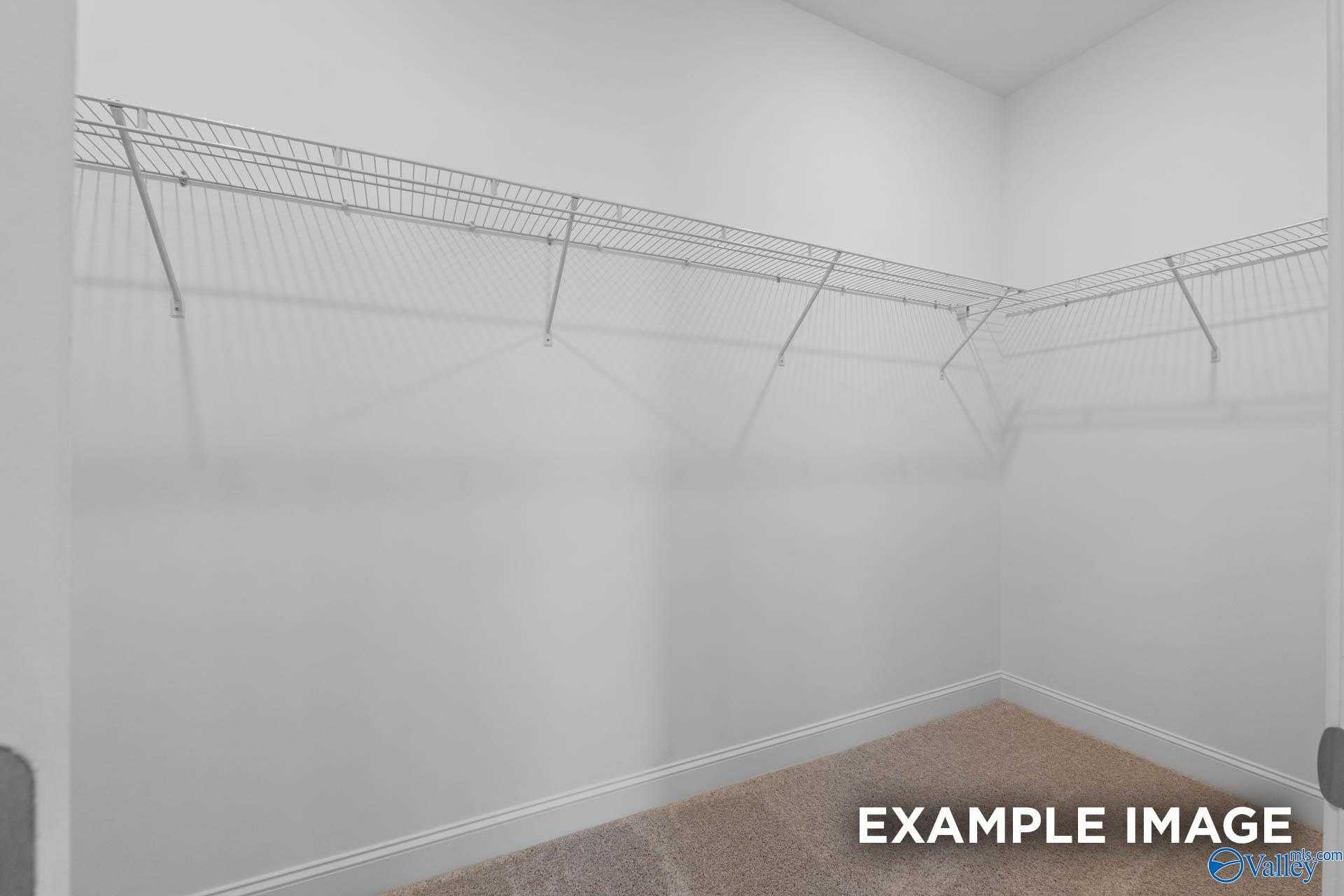 Spacious walk-in closet with wire shelving in The Montgomery B master suite by Davidson Homes, Hartselle, Alabama