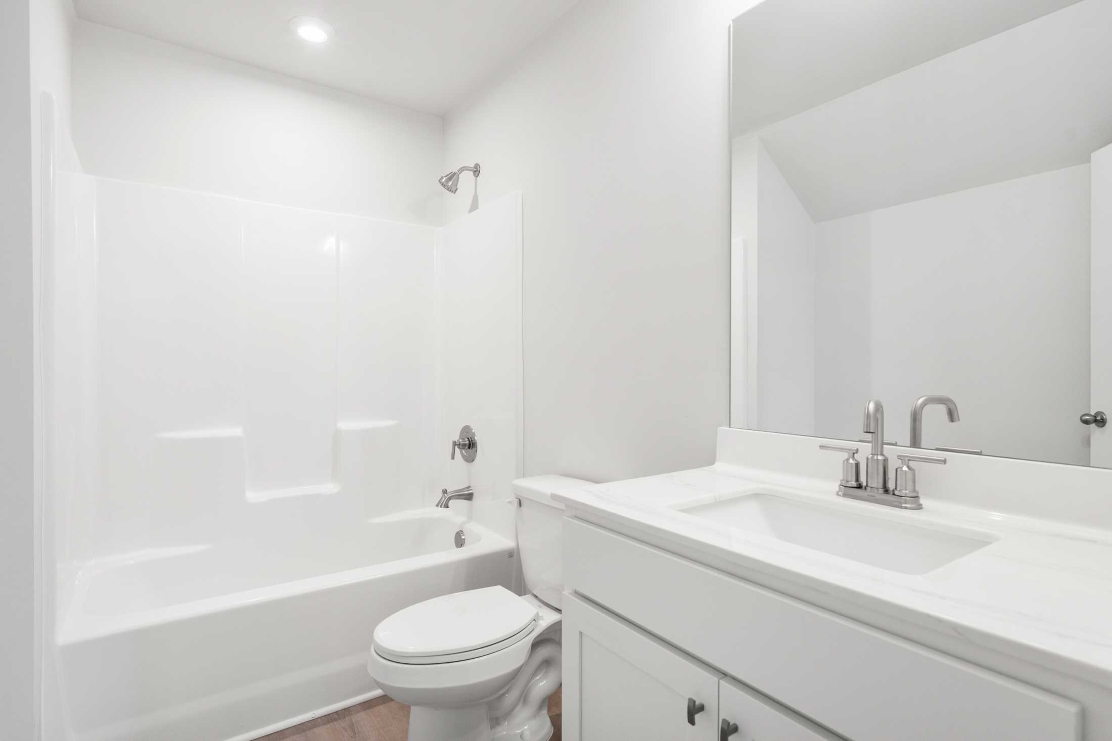 Spacious master bathroom in The Ash B at Wehunt Meadows featuring soaking tub, walk-in shower, and white vanity