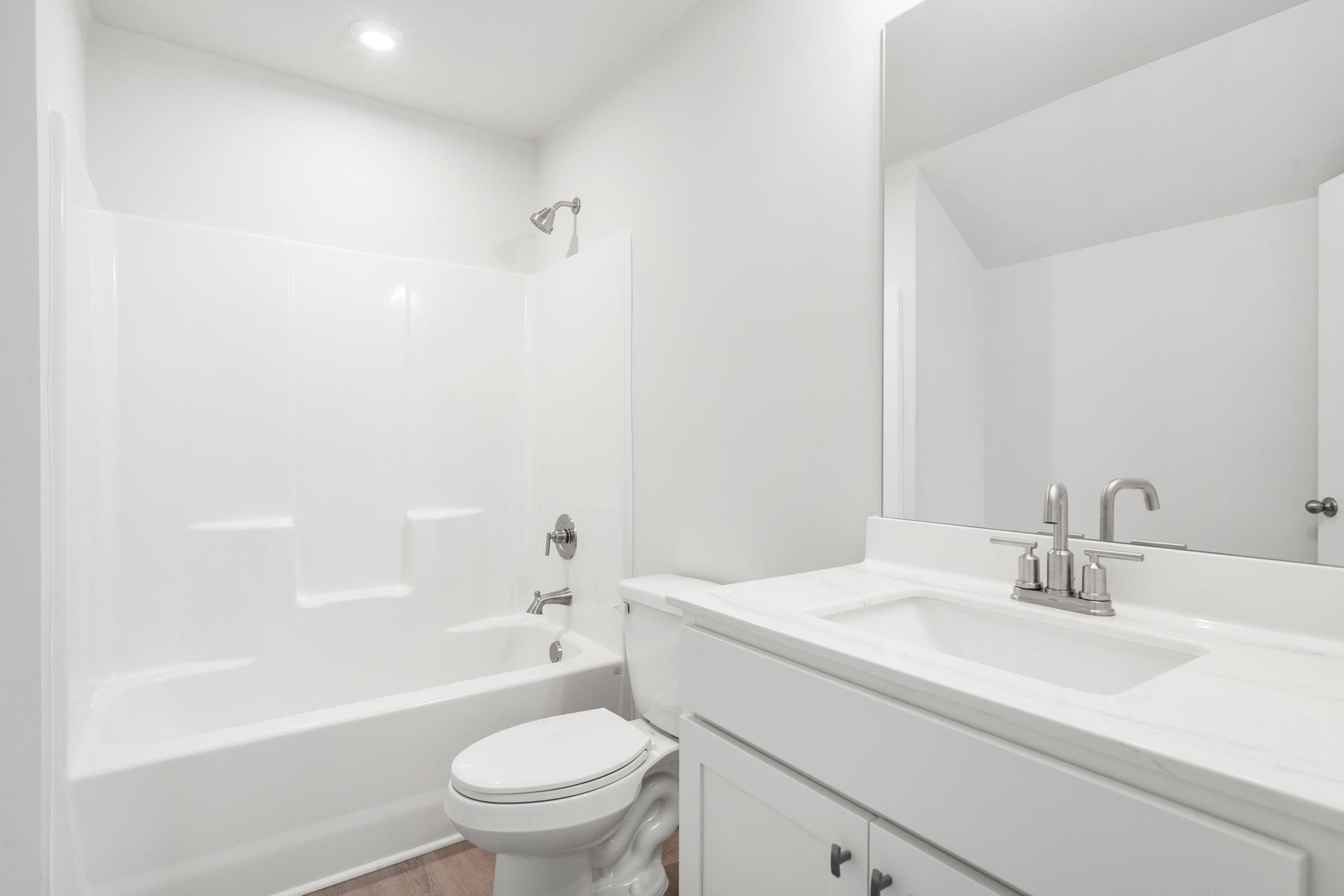 Spacious master bathroom in The Ash B at Wehunt Meadows featuring soaking tub, walk-in shower, and white vanity