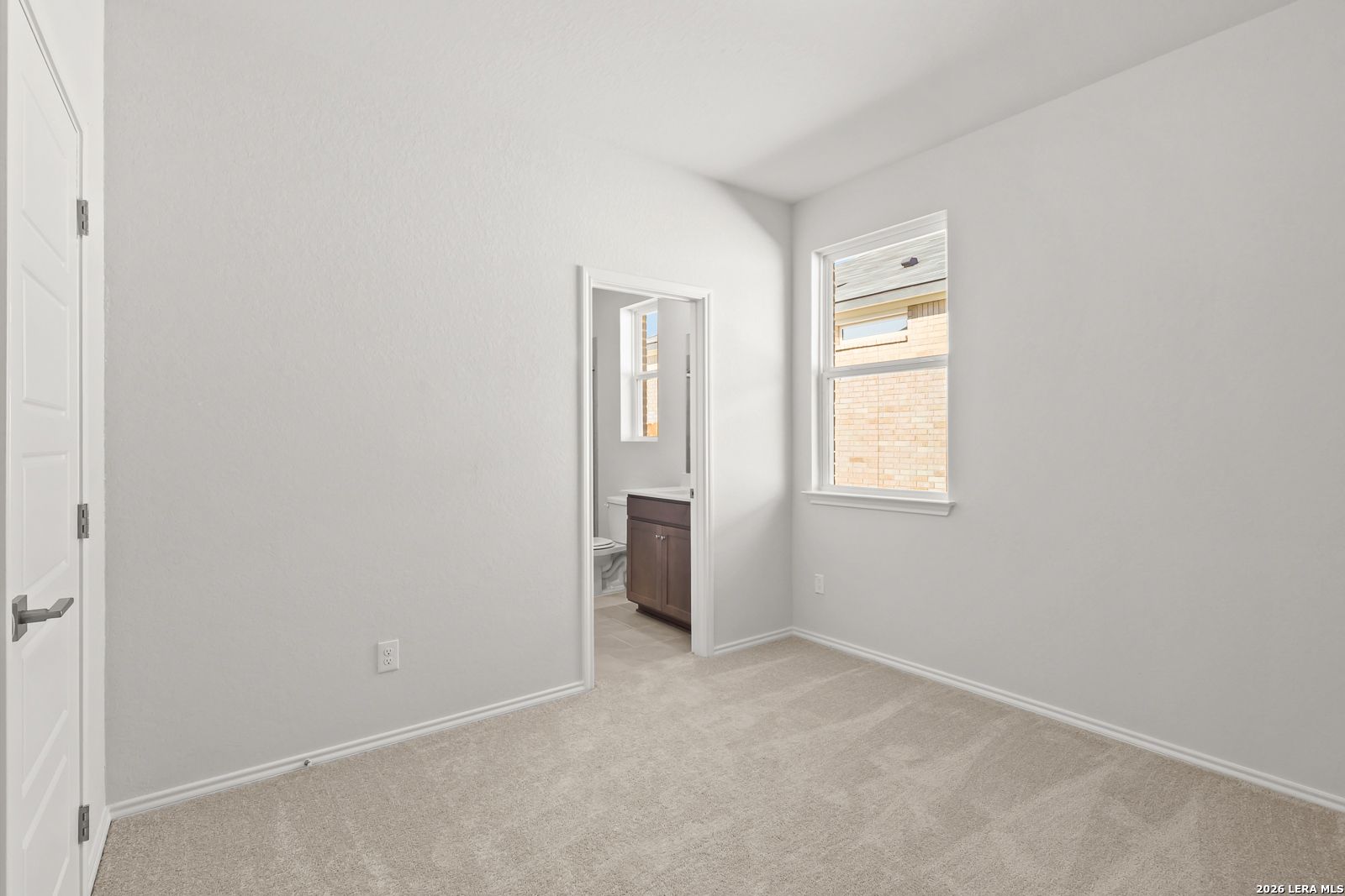Bright carpeted bedroom with natural light and private bath access in Davidson Homes The Daphne I, Bricewood, San Antonio, Texas