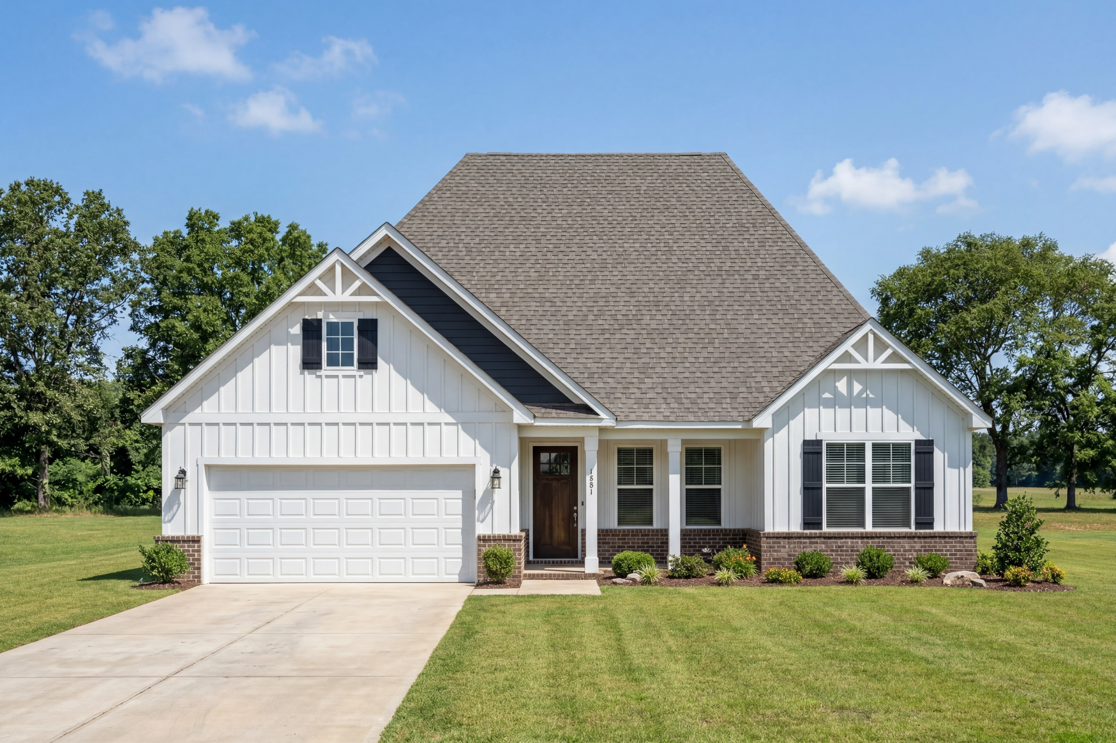 Modern farmhouse elevation of The Rockford in Cullman, Alabama featuring white vertical siding, brick accents, and garage.