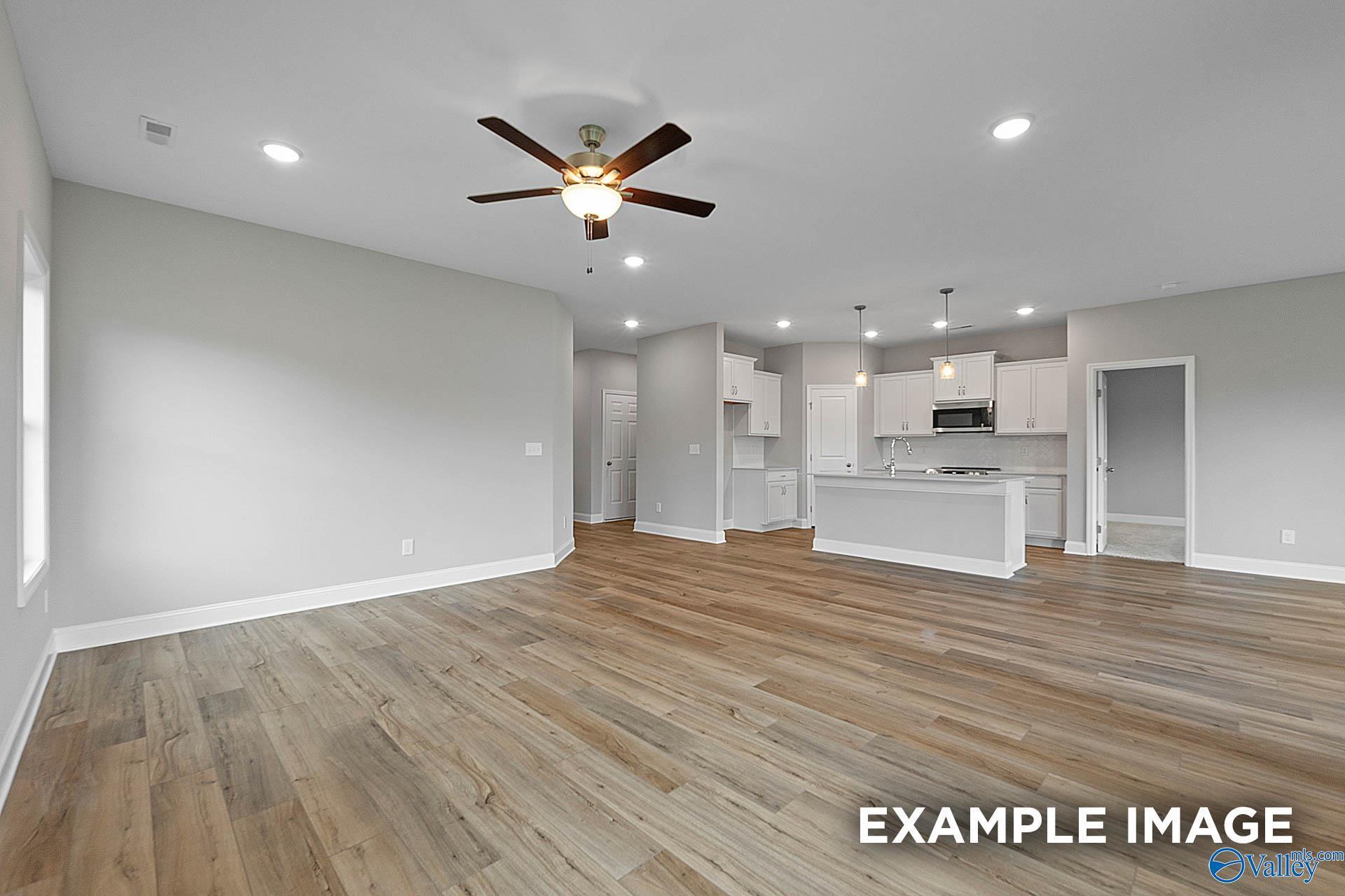 Open-concept living room and kitchen in The Franklin floor plan at Walker's Hill in Meridianville, Alabama.