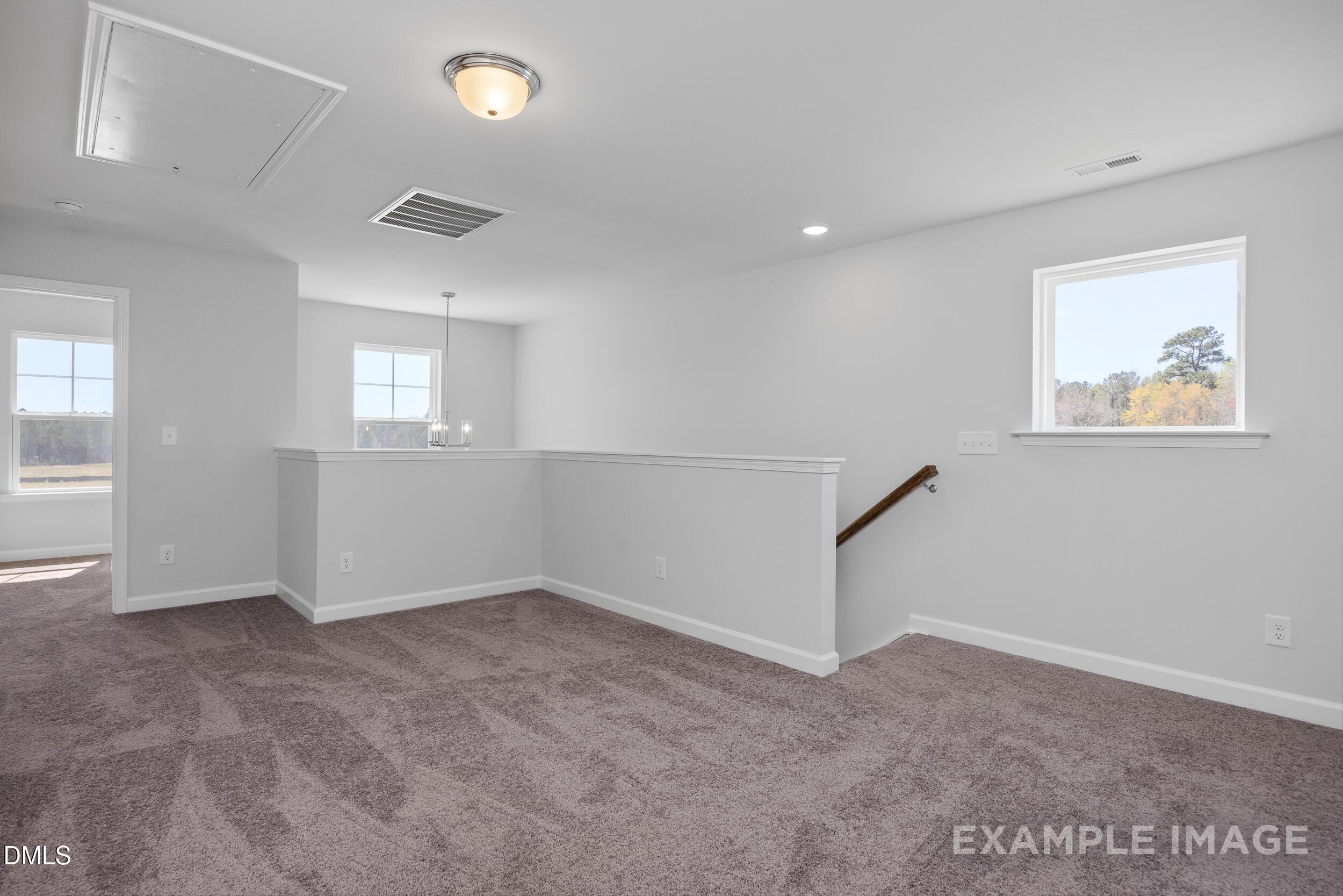 Spacious carpeted loft area in The Gavin A floor plan at Gregory Village in Lillington, North Carolina.