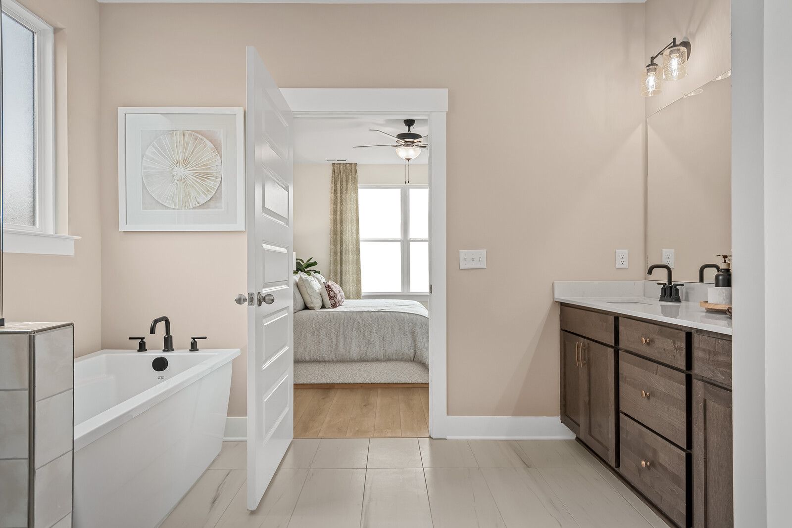 Spacious primary bathroom at Benders Cove in Mt. Juliet TN with freestanding soaking tub, double vanity, and open bedroom view