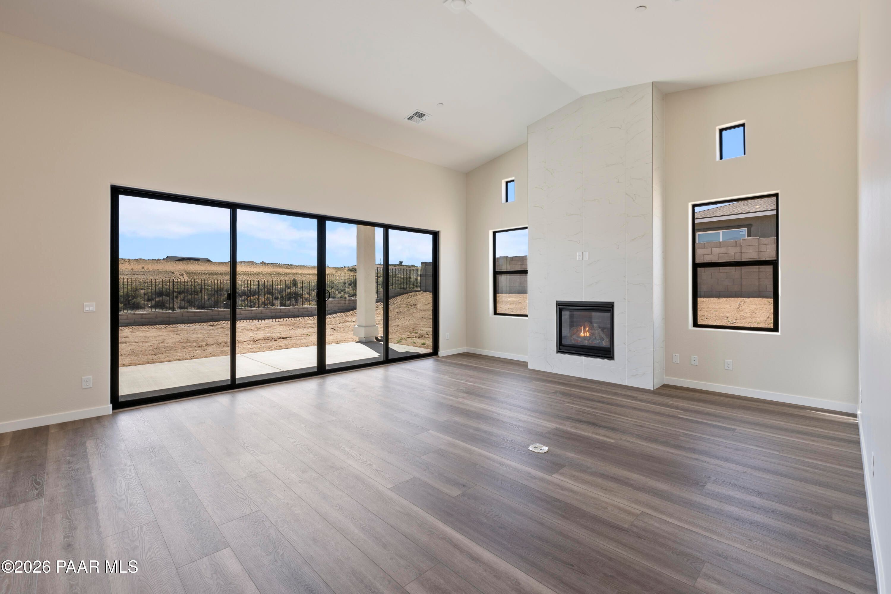 Spacious great room with gas fireplace and sliding doors to desert landscape in Davidson Homes Soleil E, Hidden Hills Prescott AZ