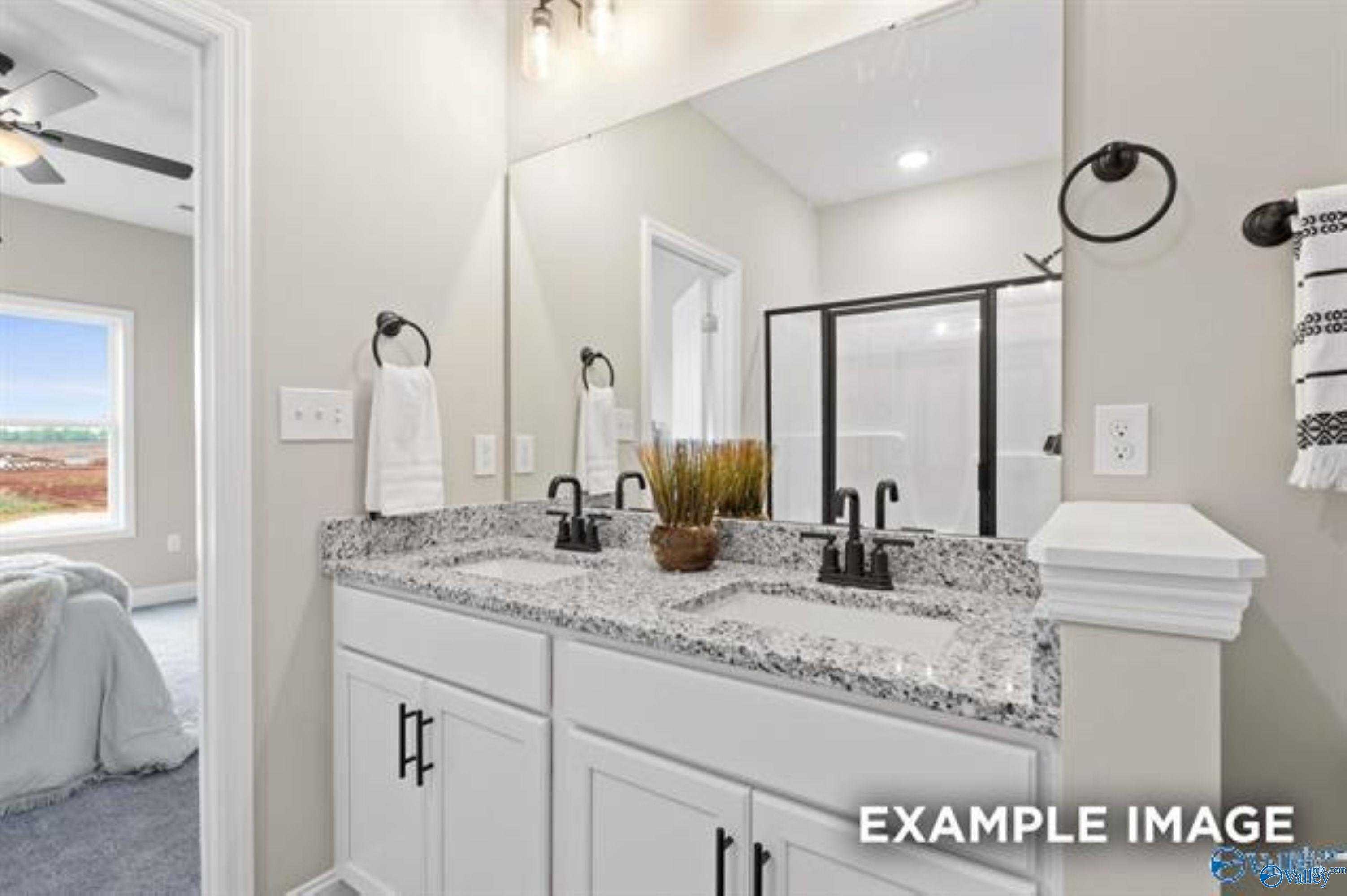 Elegant master bathroom with double granite vanity, walk-in shower, and ceiling fan in Davidson Homes The Asheville, Owens Cross Roads