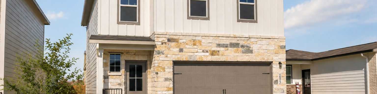 Two-story Davidson Homes exterior at Applewhite Meadows in San Antonio, TX, featuring stone accents and a two-car garage.