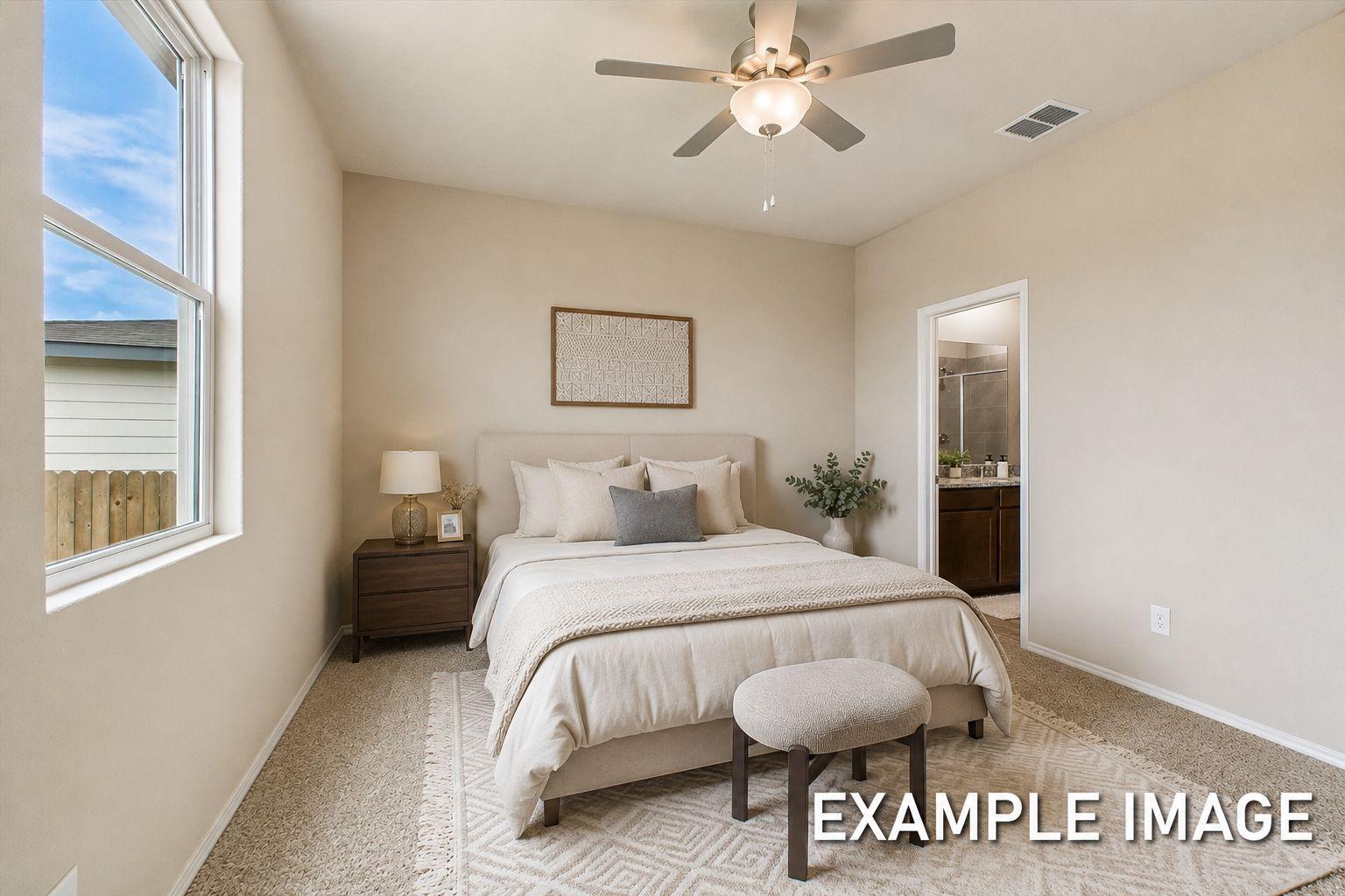 Spacious master suite in The Comal A featuring neutral decor, plush carpeting, and direct access to an en-suite bathroom.