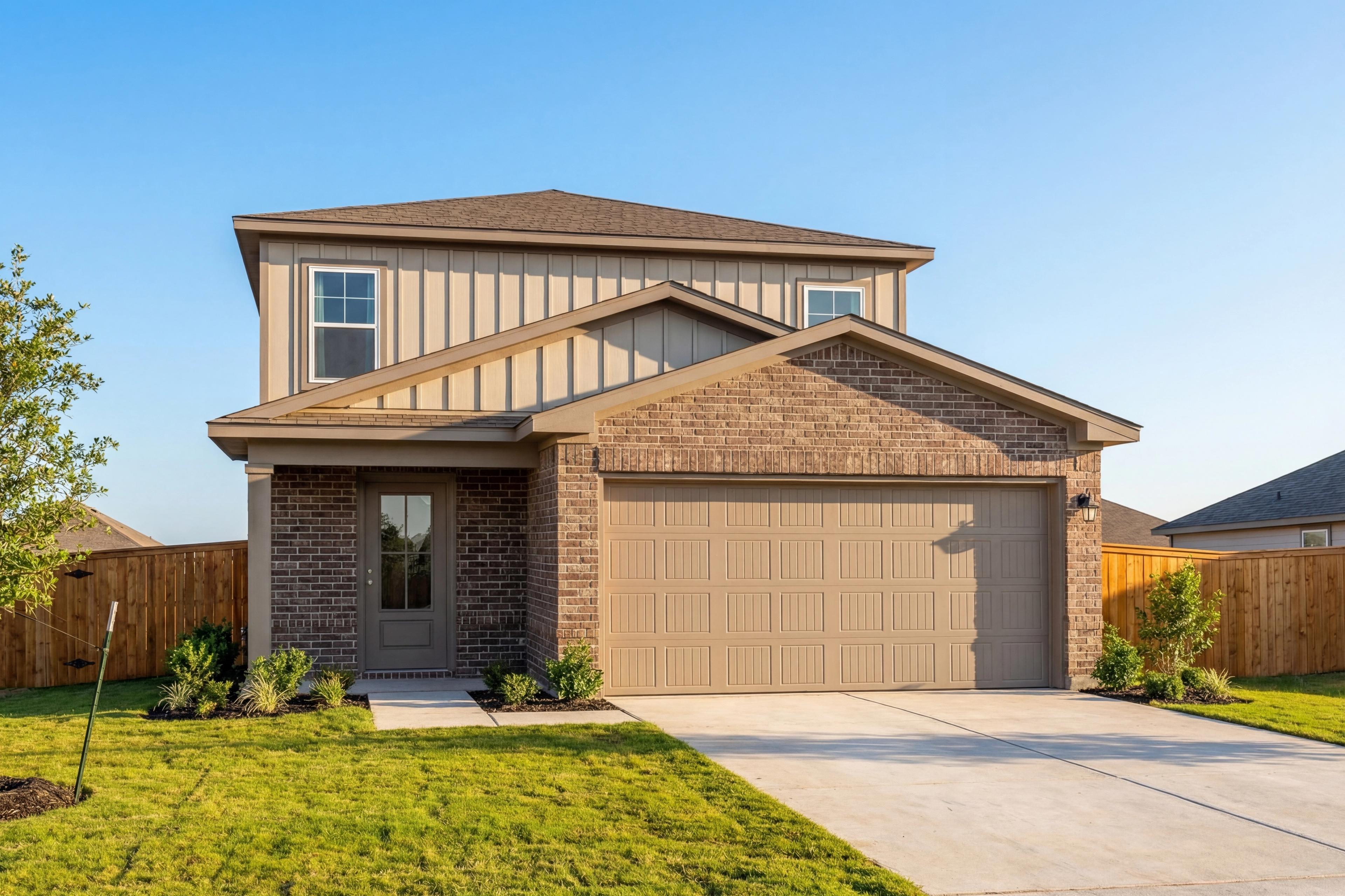 Two-story San Marcos home elevation by Davidson Homes in San Antonio, featuring brick facade, beige siding, two-car garage, and landscaped front yard
