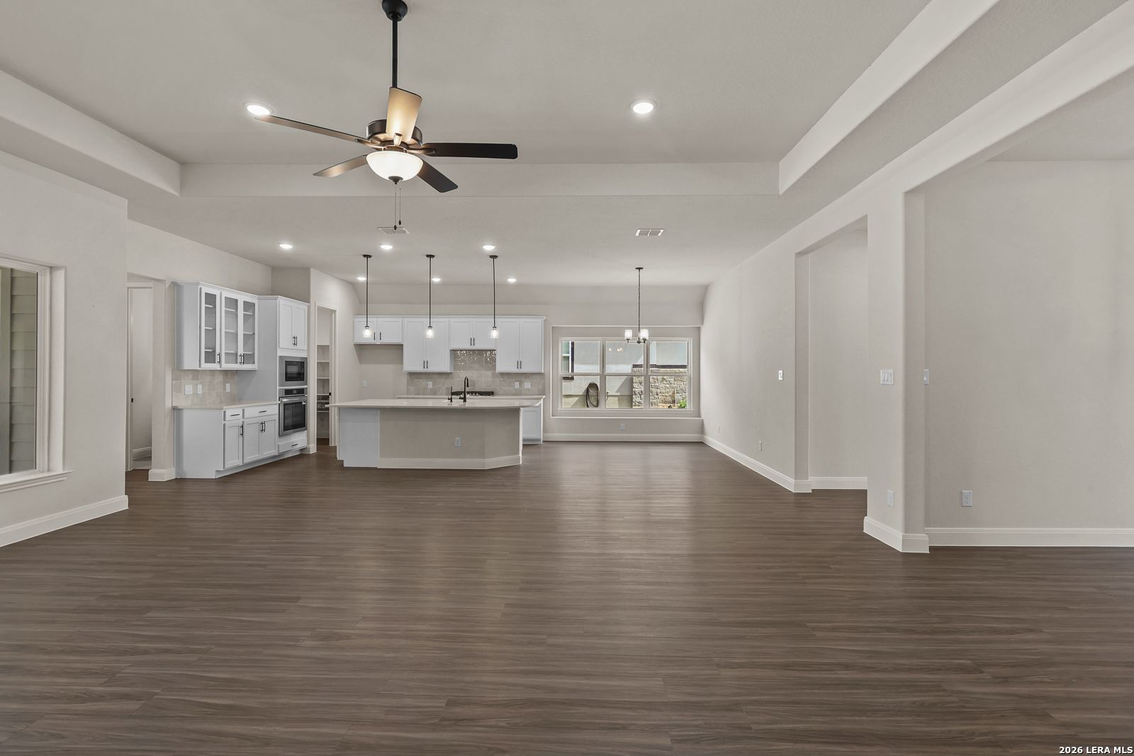 Open-concept kitchen and living area in The Summerlin B floor plan by Davidson Homes in Potranco Oaks, Castroville, Texas.