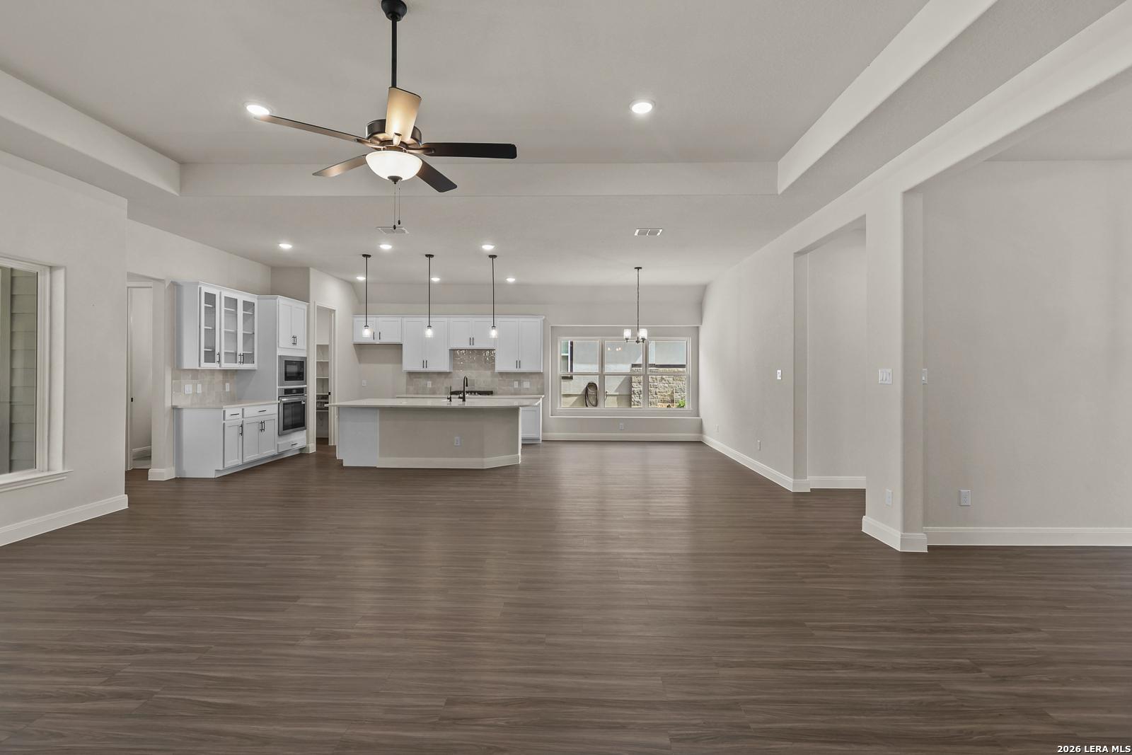 Open-concept kitchen and living area in The Summerlin B floor plan by Davidson Homes in Potranco Oaks, Castroville, Texas.