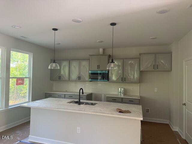 Modern kitchen with large island and pendant lighting in The Chestnut floor plan by Davidson Homes in Montrose, Aberdeen.