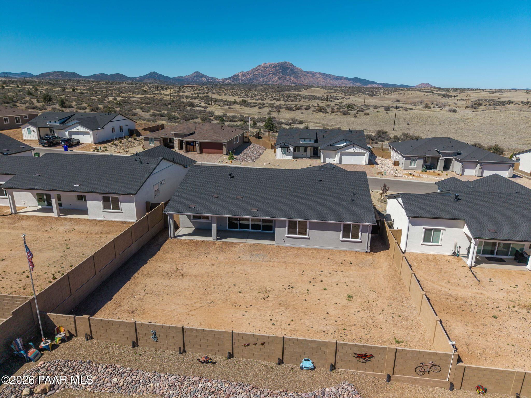 Aerial view of modern single-story Monarch A home by Davidson Homes in Westwood, Prescott AZ desert with mountain backdrop