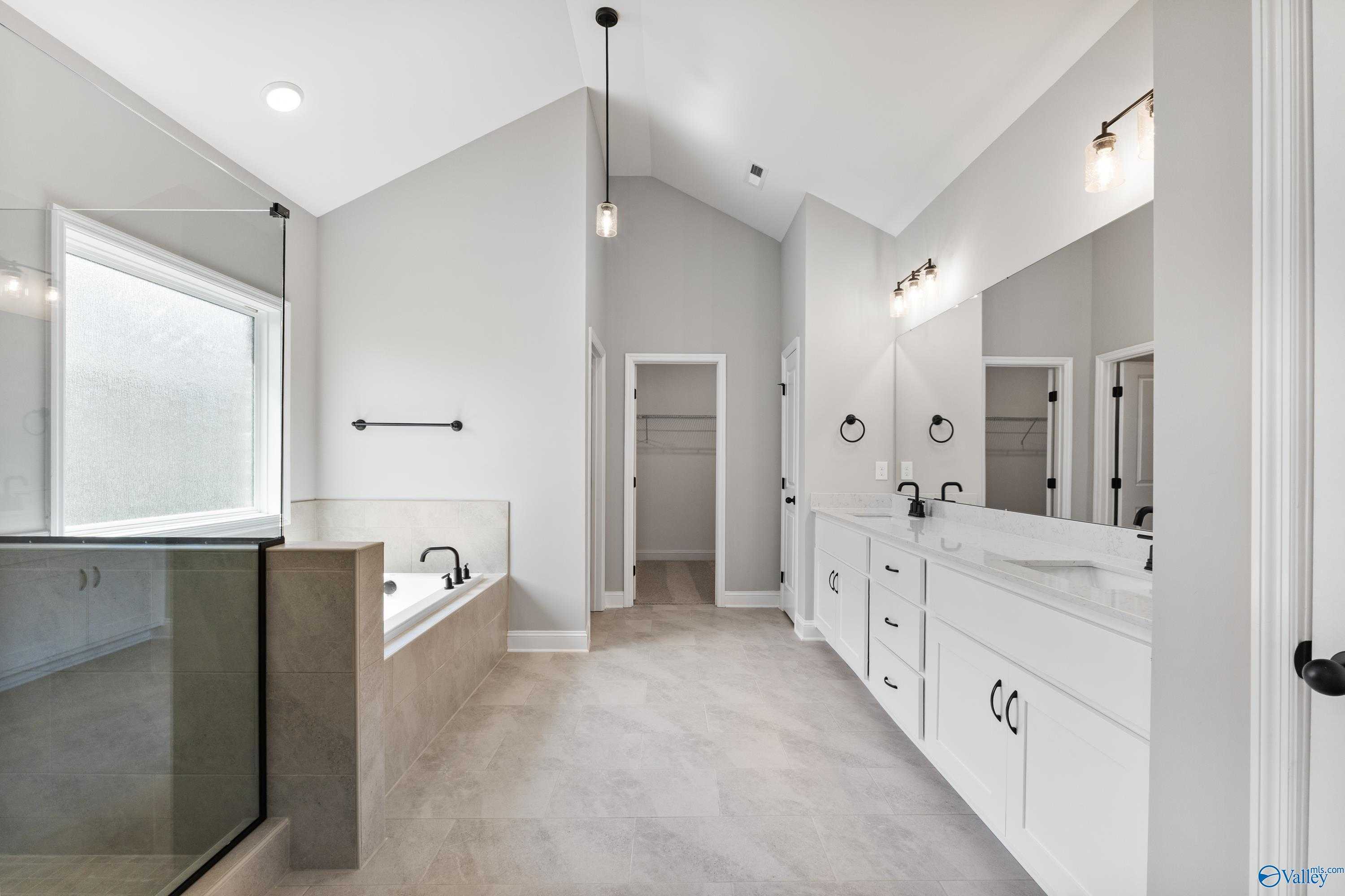 Luxurious master bath with freestanding soaking tub, glass walk-in shower, and double vanity in Davidson Homes The Finleigh, Toney, Alabama