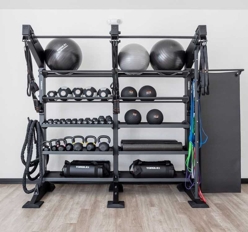 Well-equipped home gym with dumbbell racks, kettlebells, exercise balls, and resistance bands in Davidson Homes The Hathaway, Murfreesboro, TN