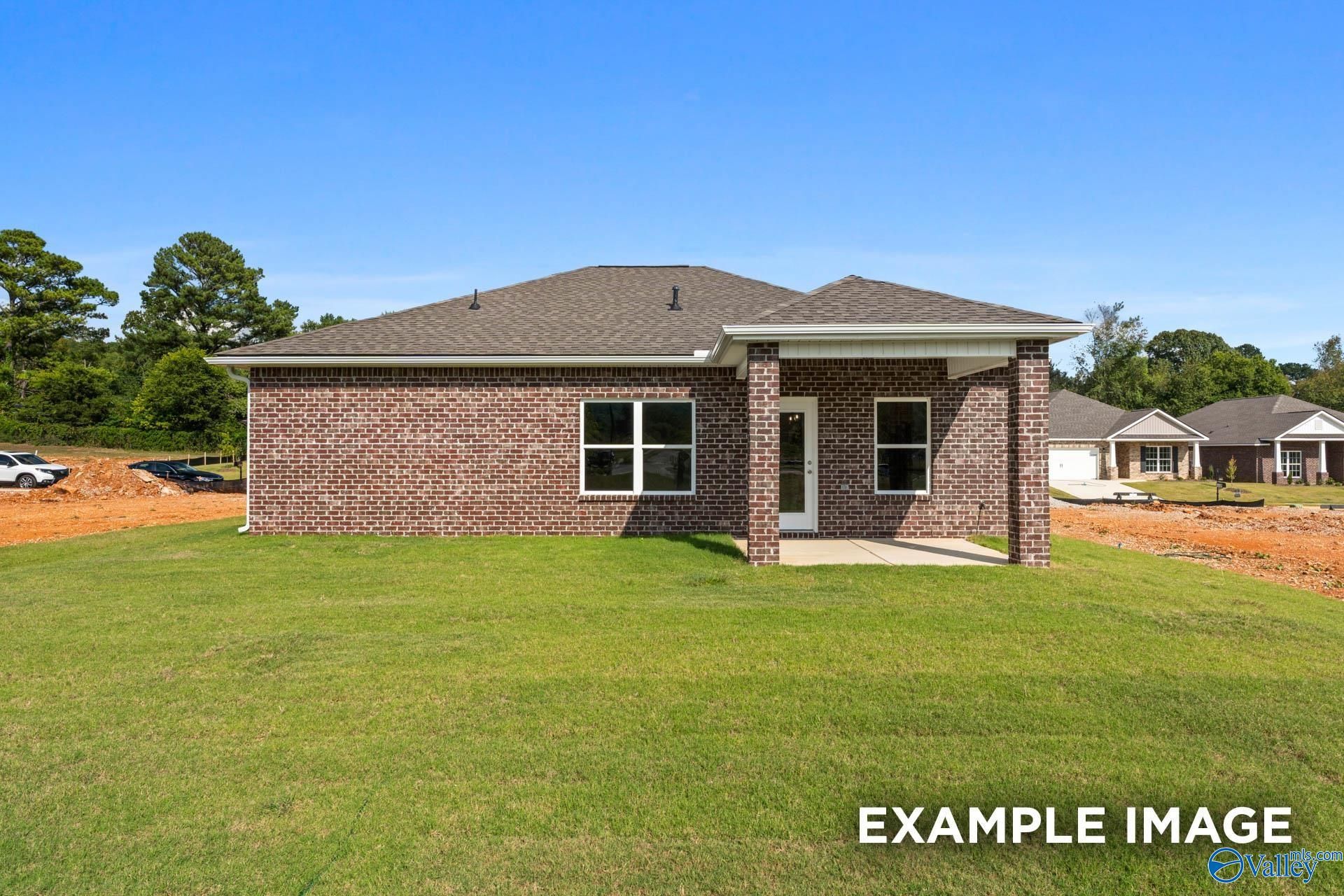 Brick single-story 3-bedroom home with 2-car garage, red brick exterior and green lawn in Ramsay Cove, Owens Cross Roads, Alabama
