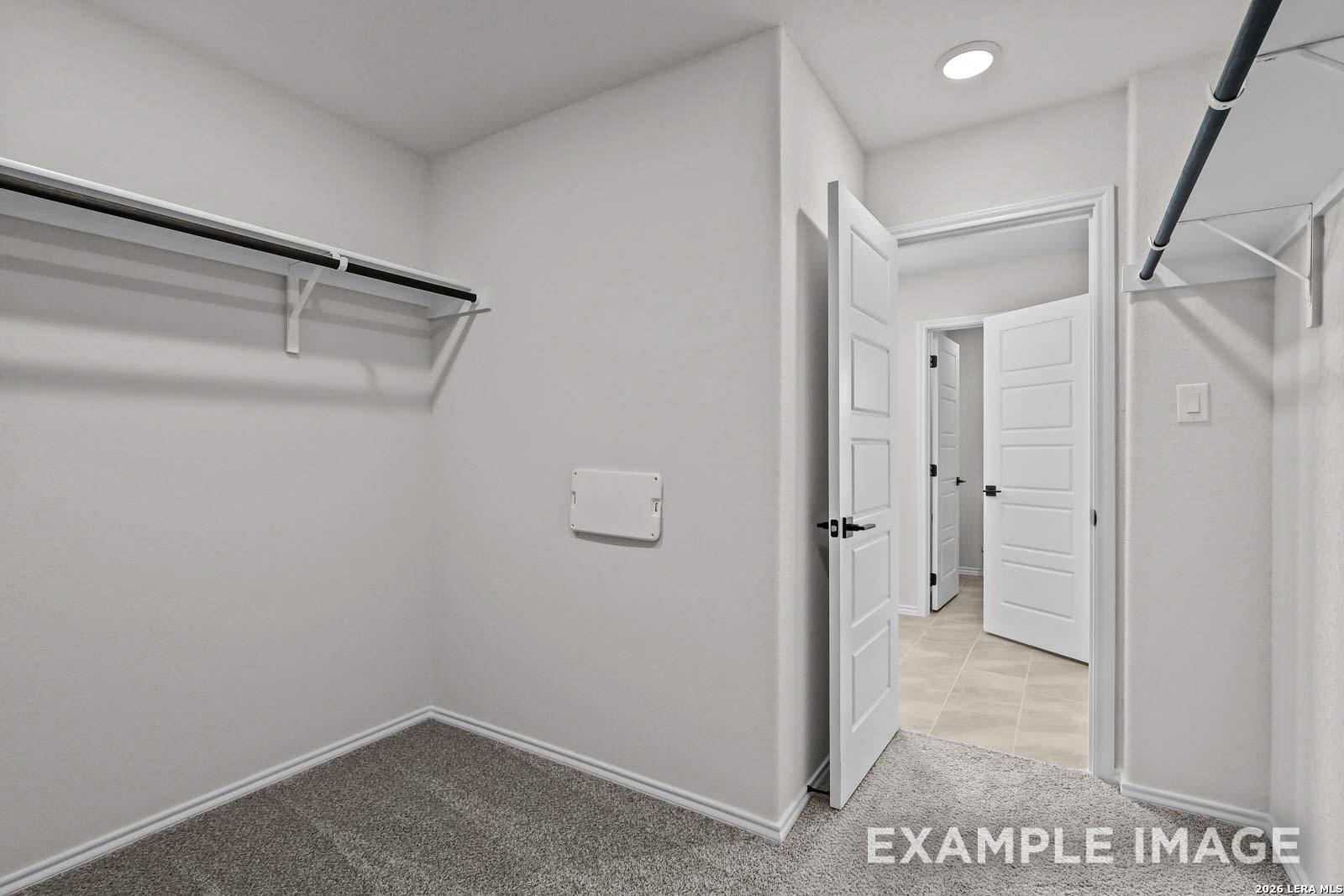 Spacious walk-in closet with shelving in The Florence D floor plan by Davidson Homes, Cedar Heights, San Antonio, Texas.