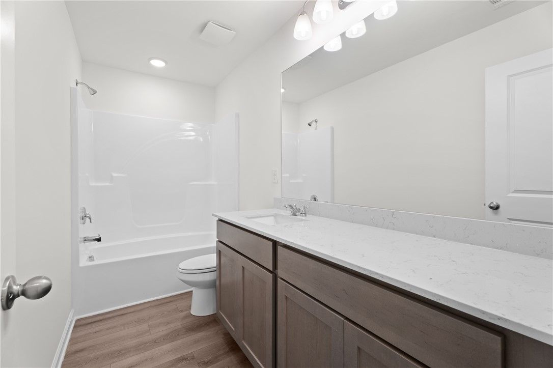 Modern bathroom with vanity, quartz countertop, and tub-shower combo in The Stella D floor plan at Silver Oak, Cusseta.